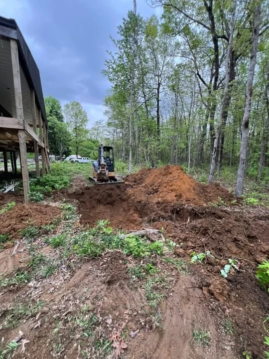 Open trench for underground utility line installation on a residential property in Grundy County, TN
