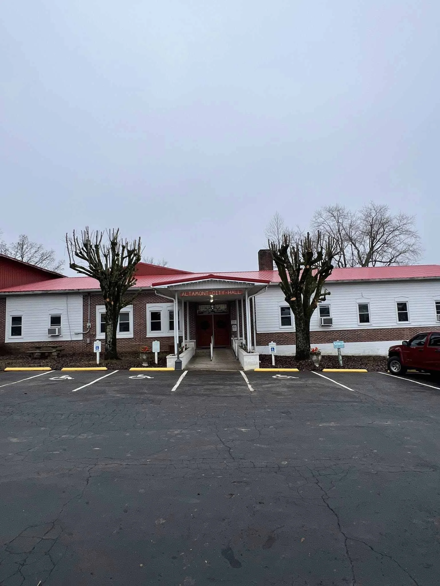 After tree trimming in Altamont, TN showing improved clearance and curb appeal near City Hall