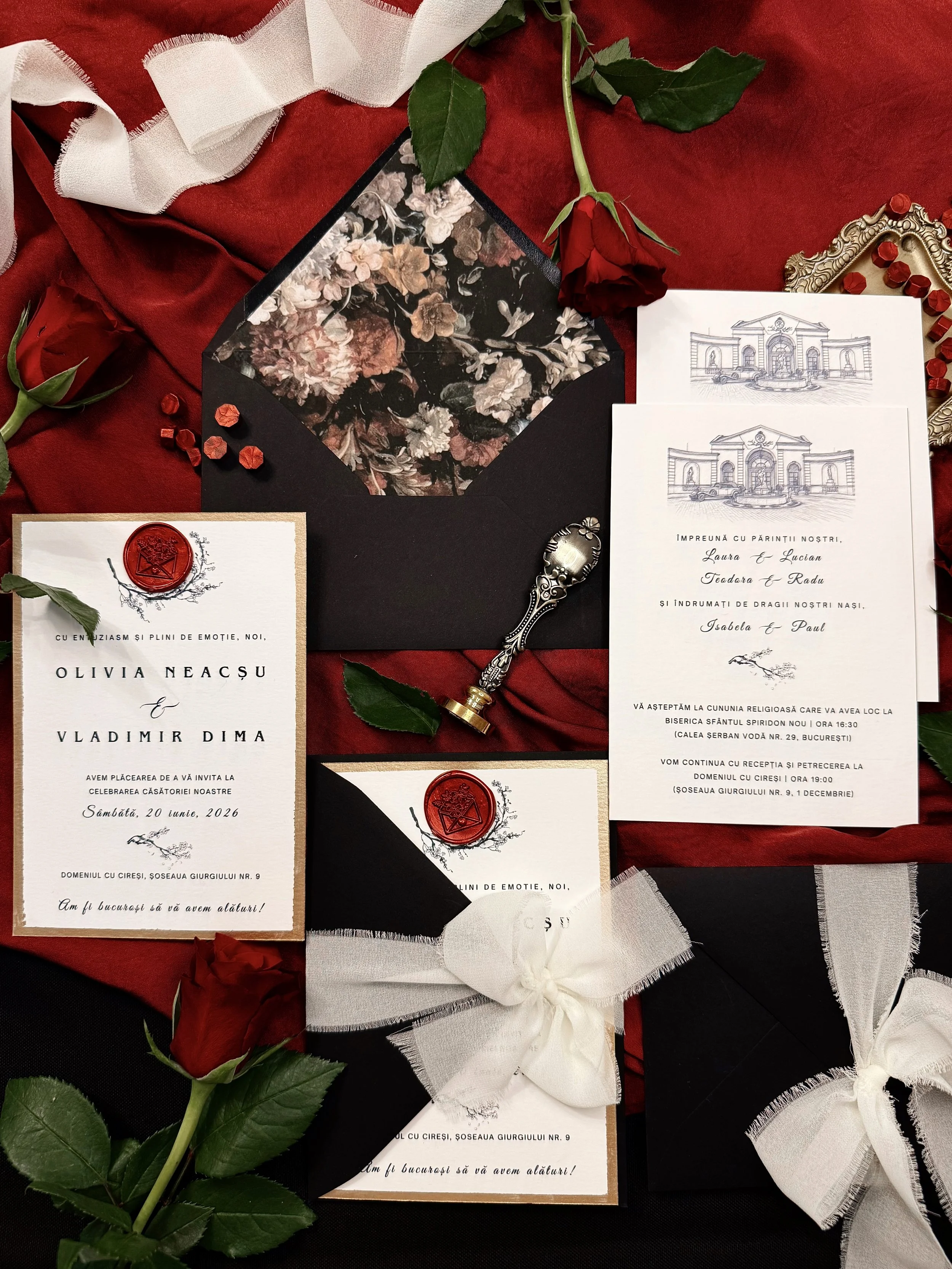 Wedding invitation suite with floral and red accents, red roses, wax seals, and elegant ribbons.