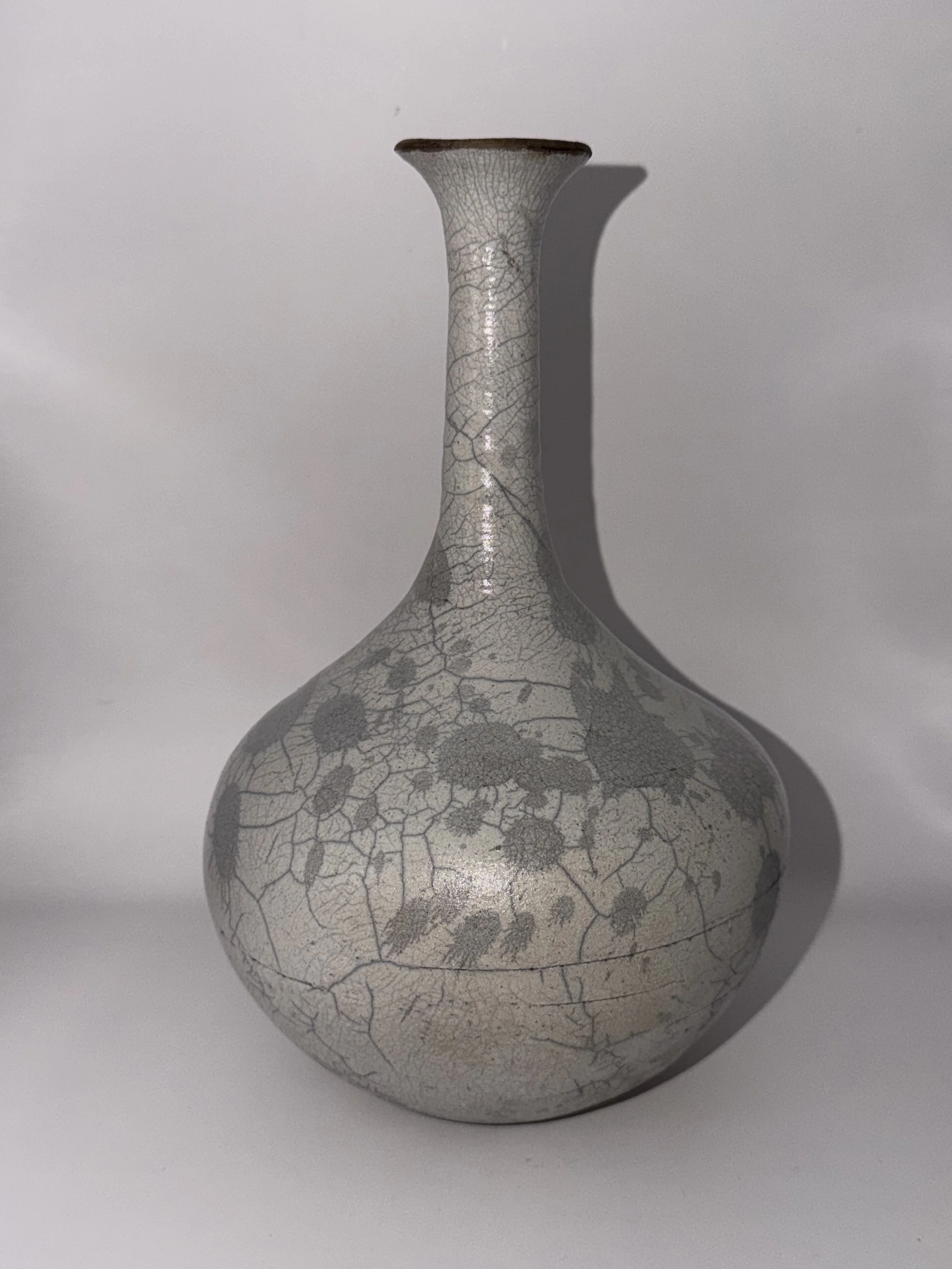This beauty is raku fired, for a unique look.  Raku pieces are not vitrified, so this would be for dry flowers only.