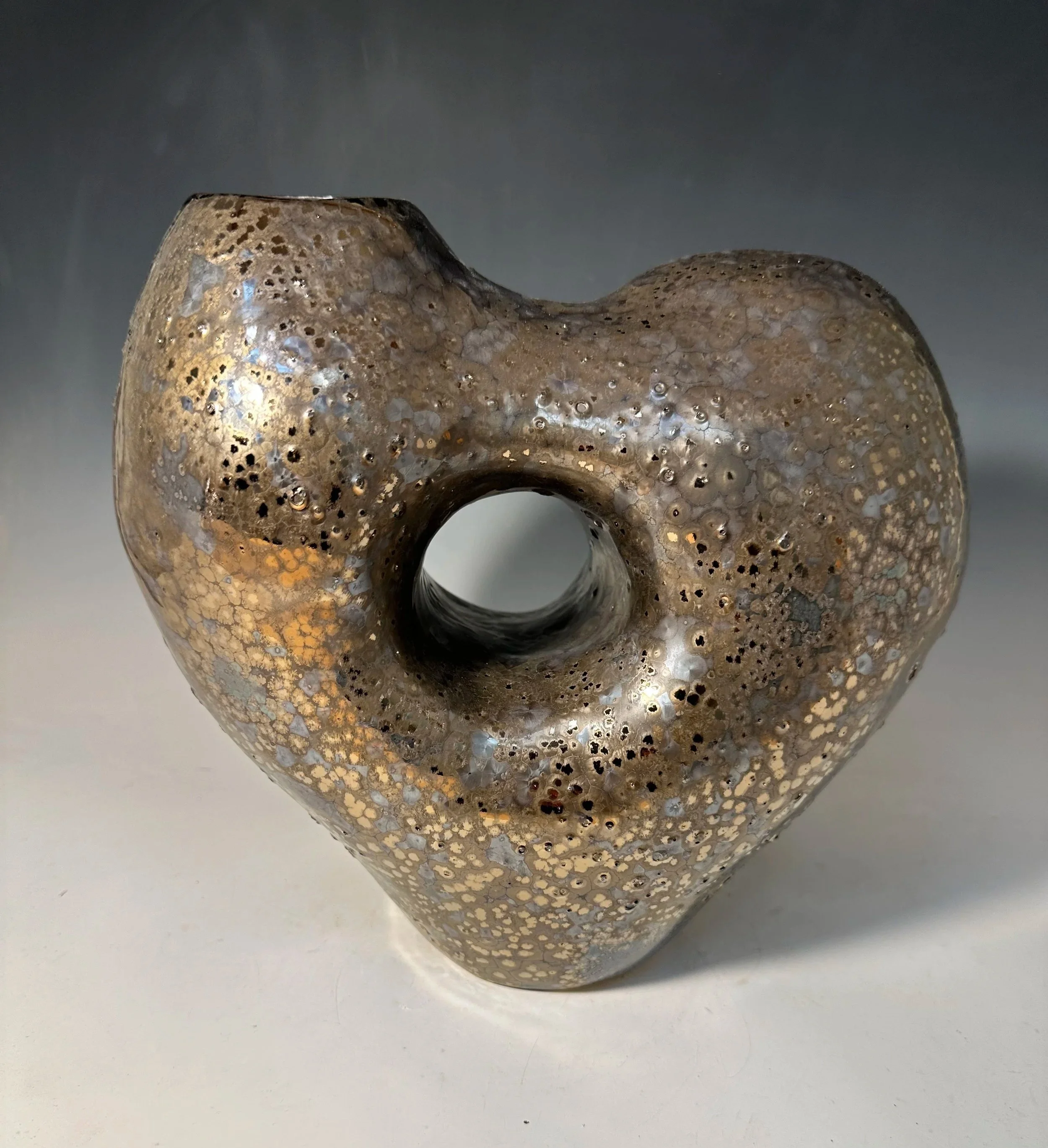 The heart vase - Coil built vessle.  The hole comes from all those we have lost and miss.