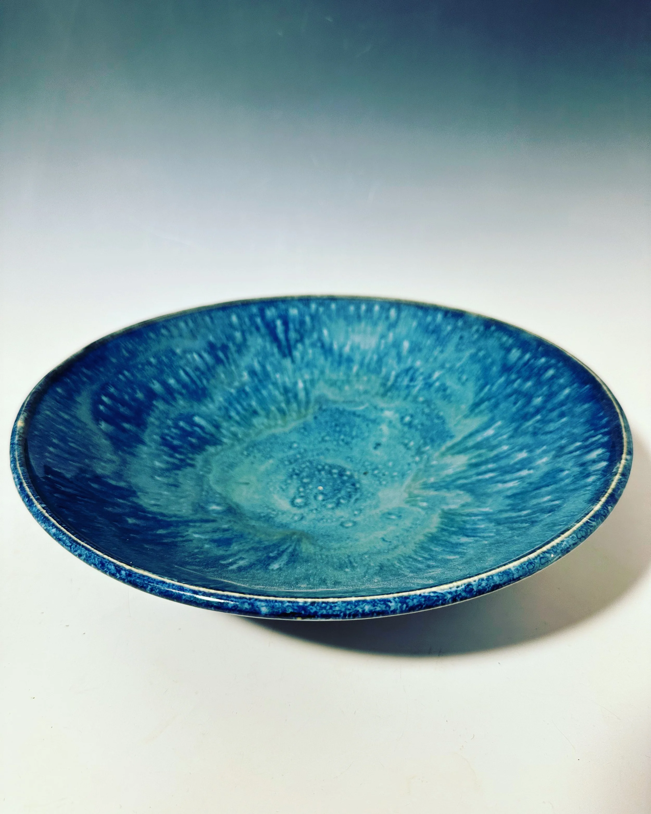 Deep blues, with what feels like raindrops.  I have not been able to exactly recreate it.  12 " wide and 2 high.