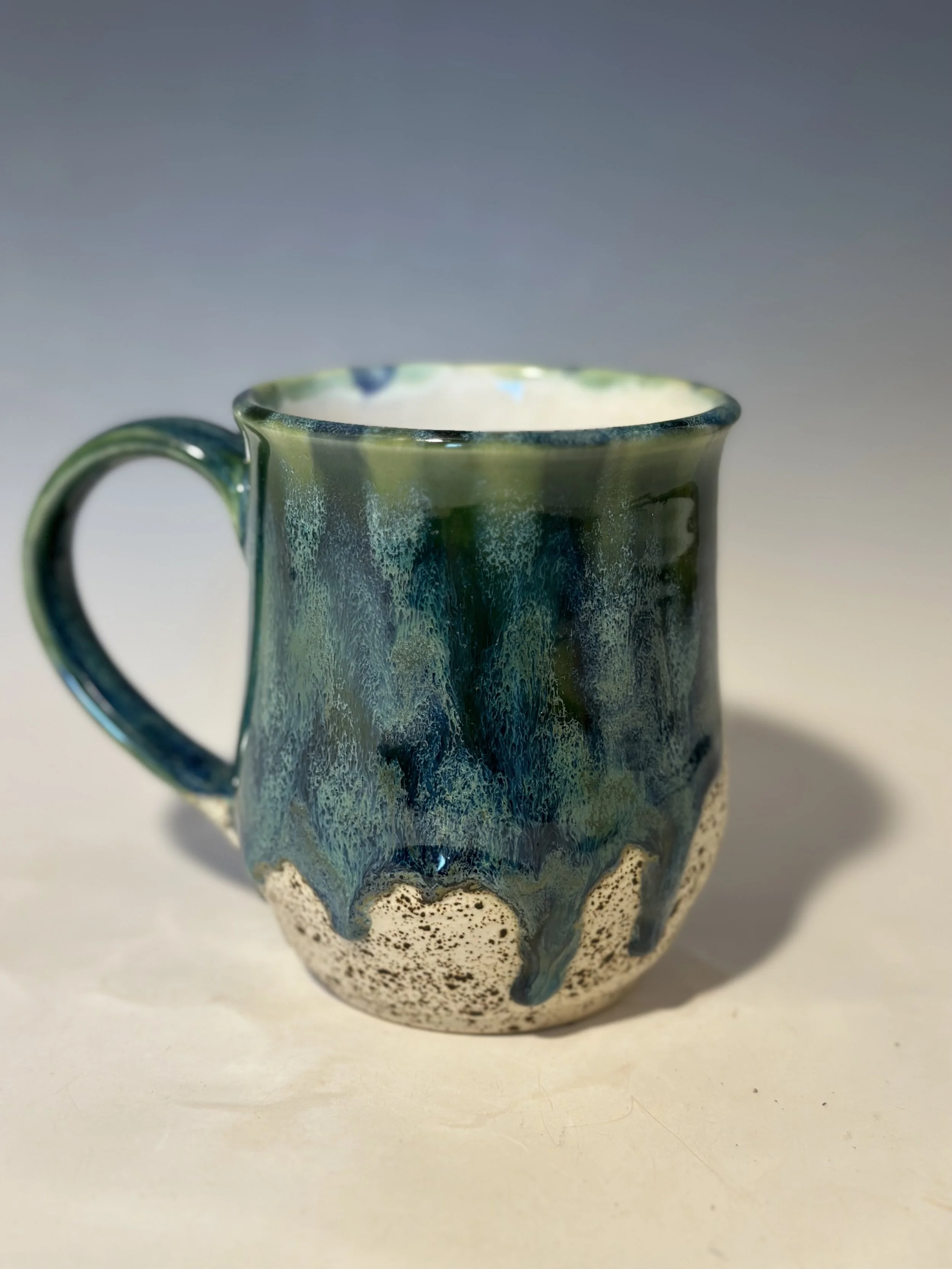 Mug with my favorite glaze combo.  The bottom is a matte sandy texture.