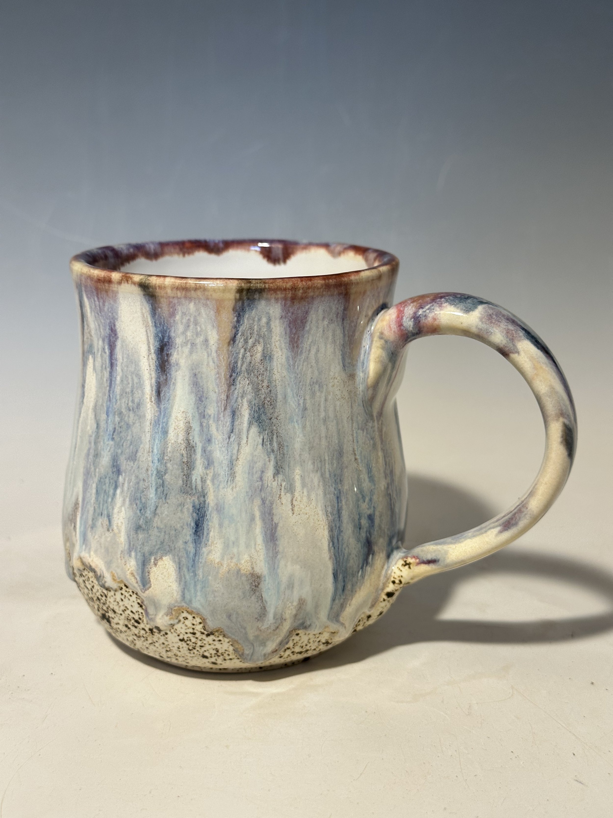 The drips on this rock.  Sandy bottom with a white interior, all  shades of blue and cream with a dab of pink.