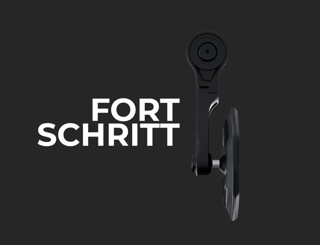 A black bicycle pedal and crank arm against a dark background, with the words "FORT SCHRITT" written in white next to it.