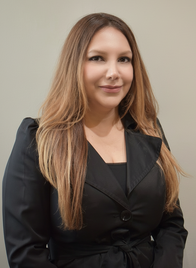 A woman with long, light brown hair wearing a black blazer.