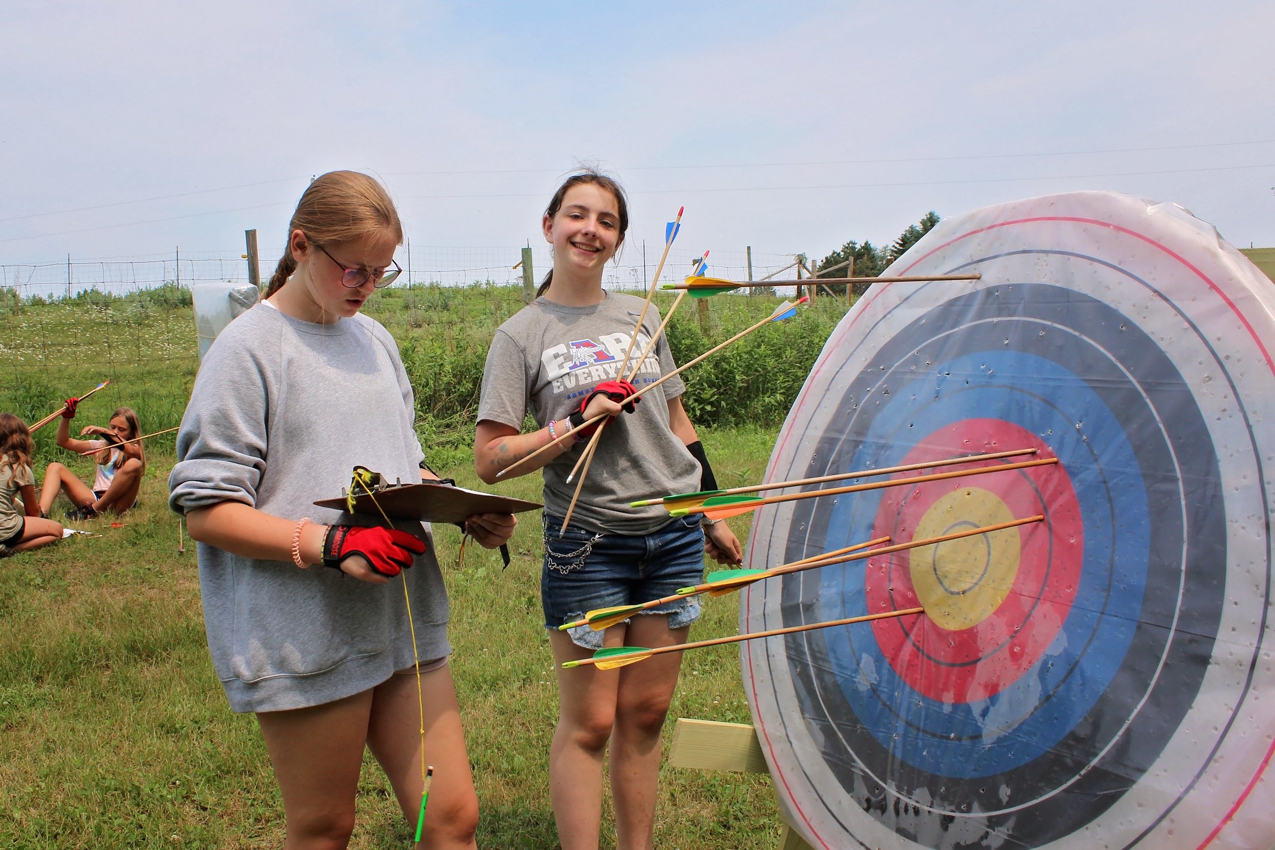 Two girls getting arrows out of target