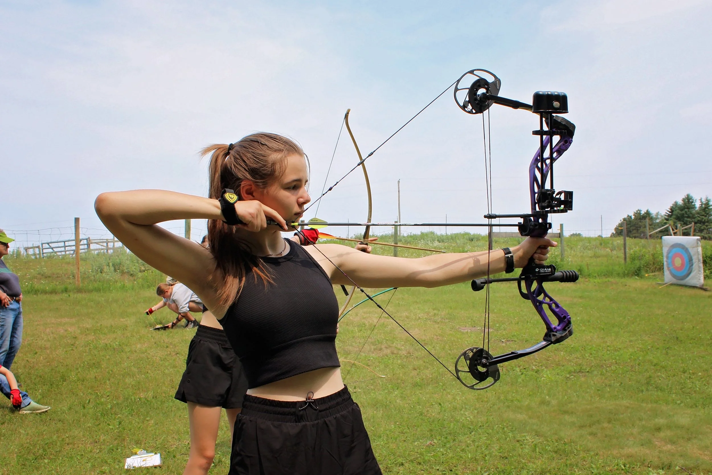 Girl using compound bow