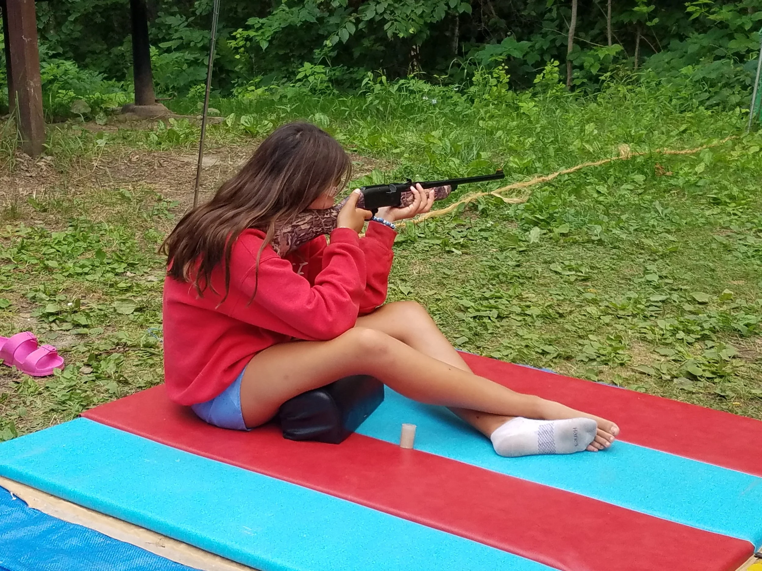 One girl sitting to shoot bb gun