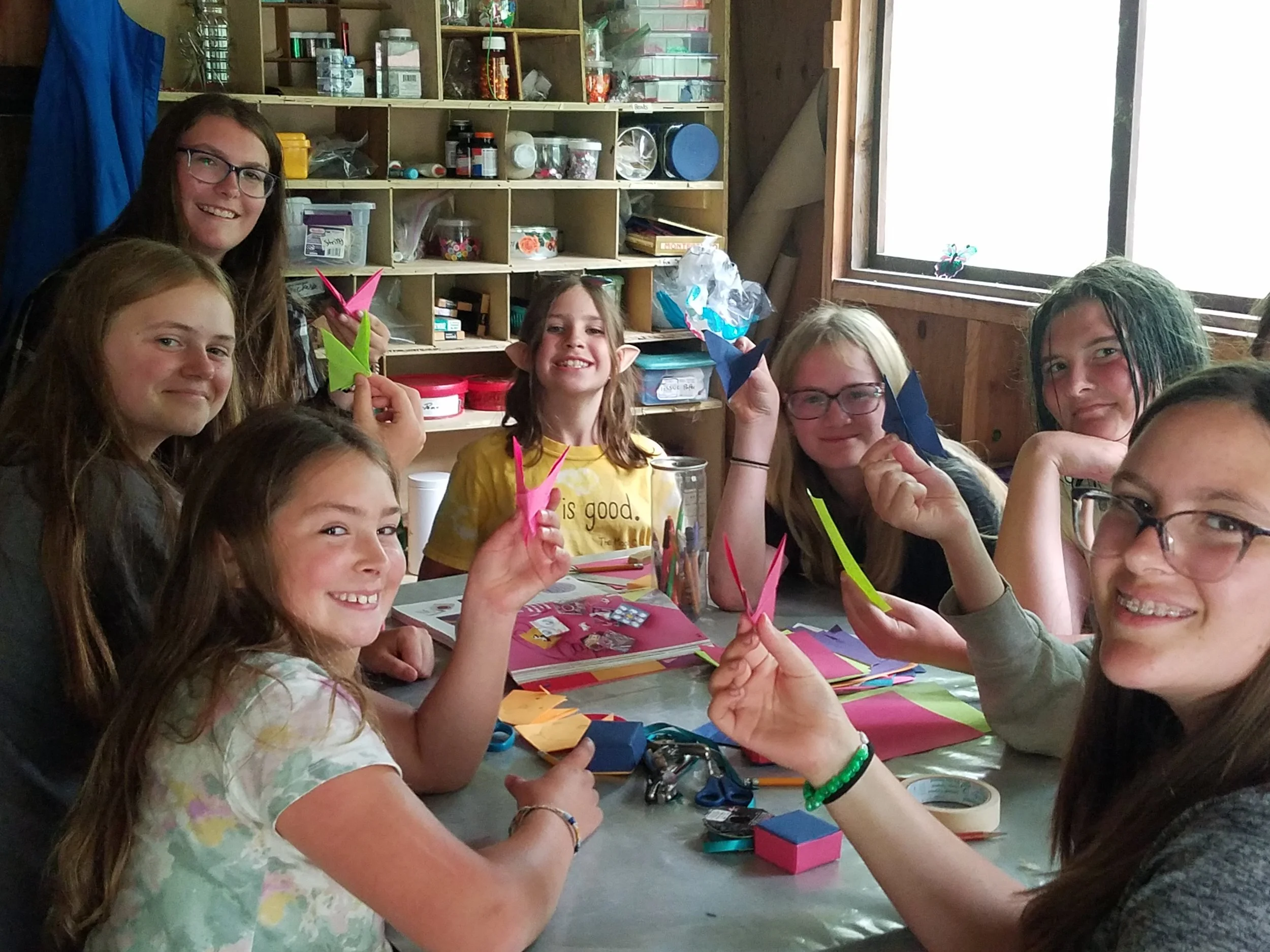 Seven girls showing crafts projects