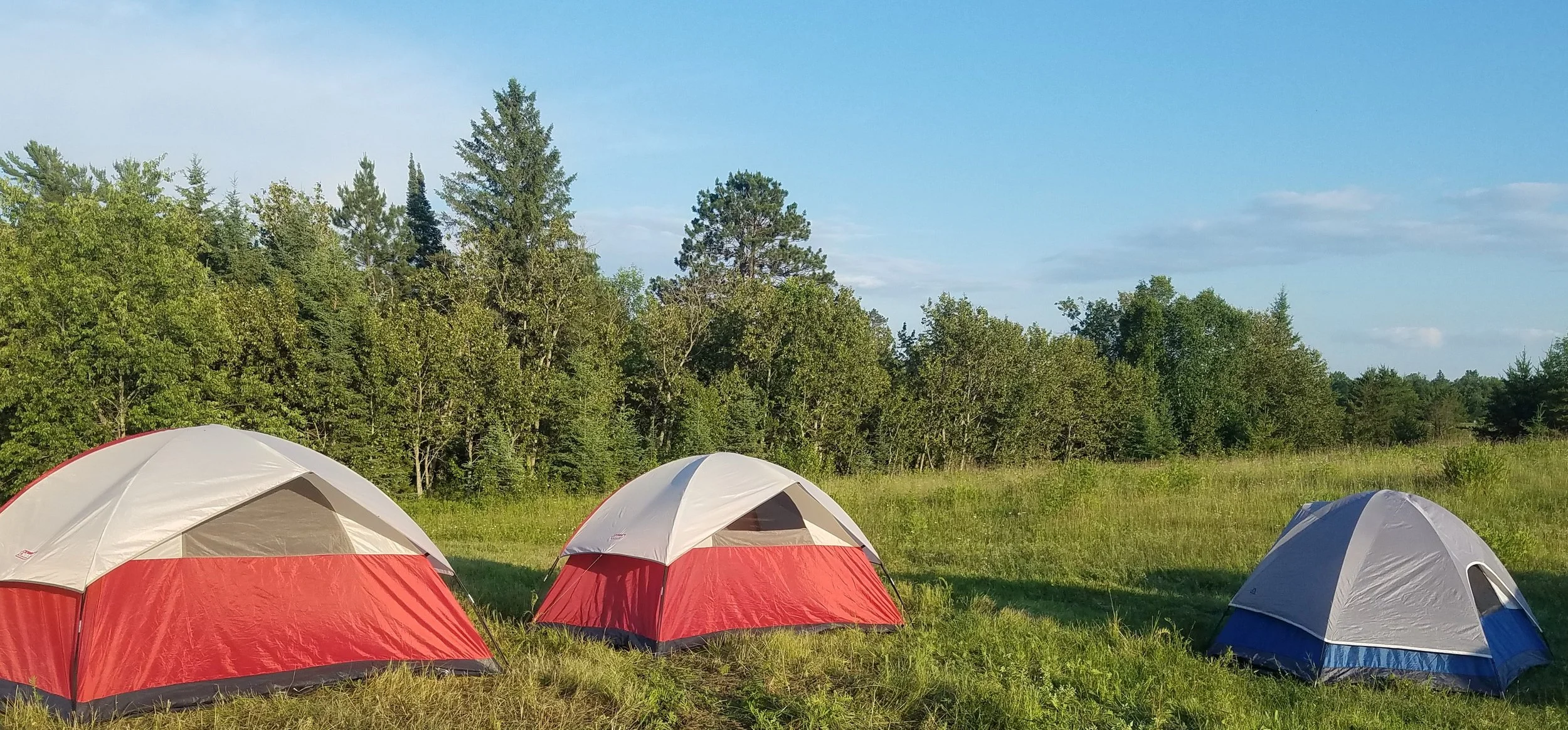 Two reds tents and one blue tent