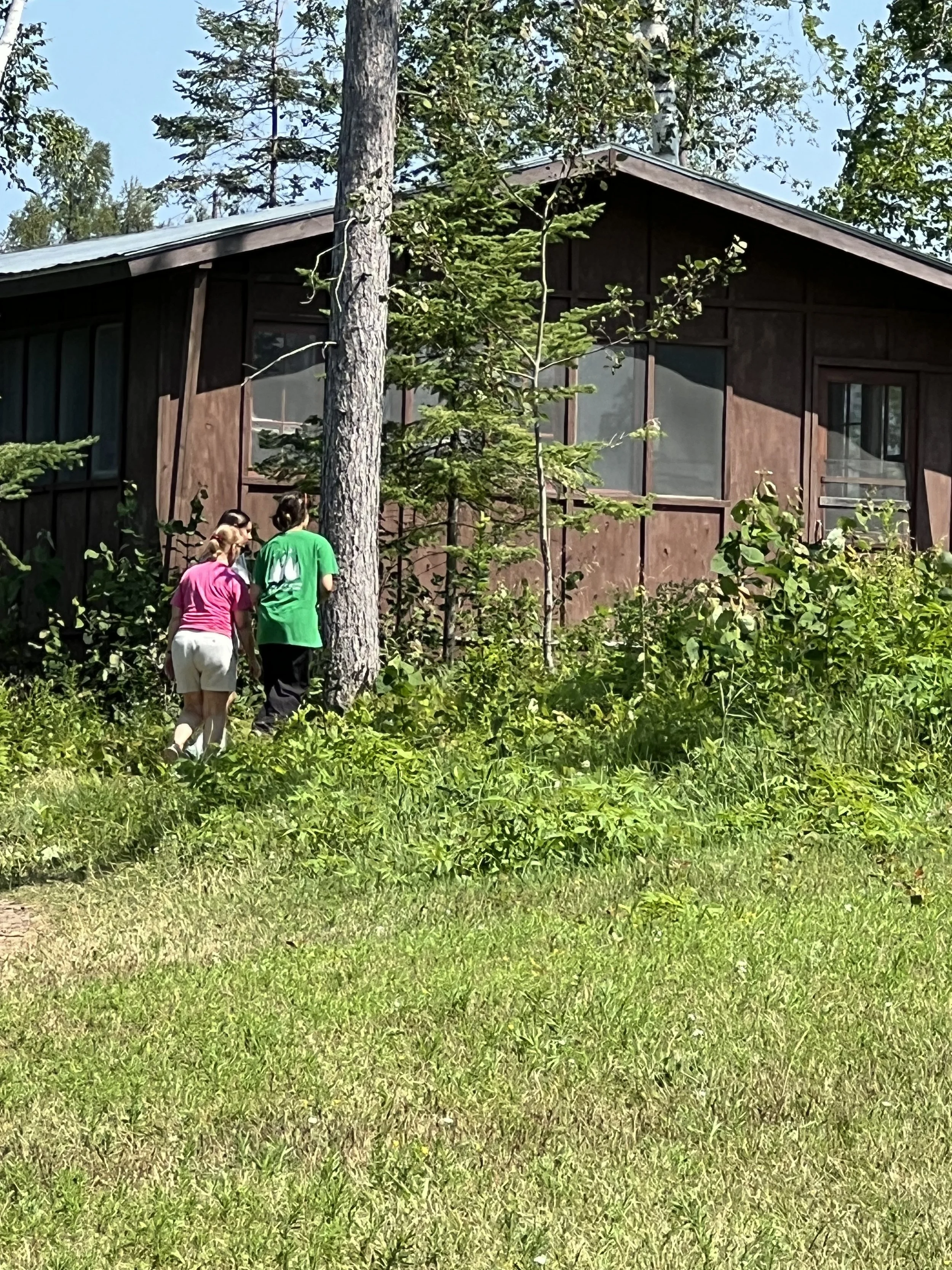 Exterior cabin with girls in front.