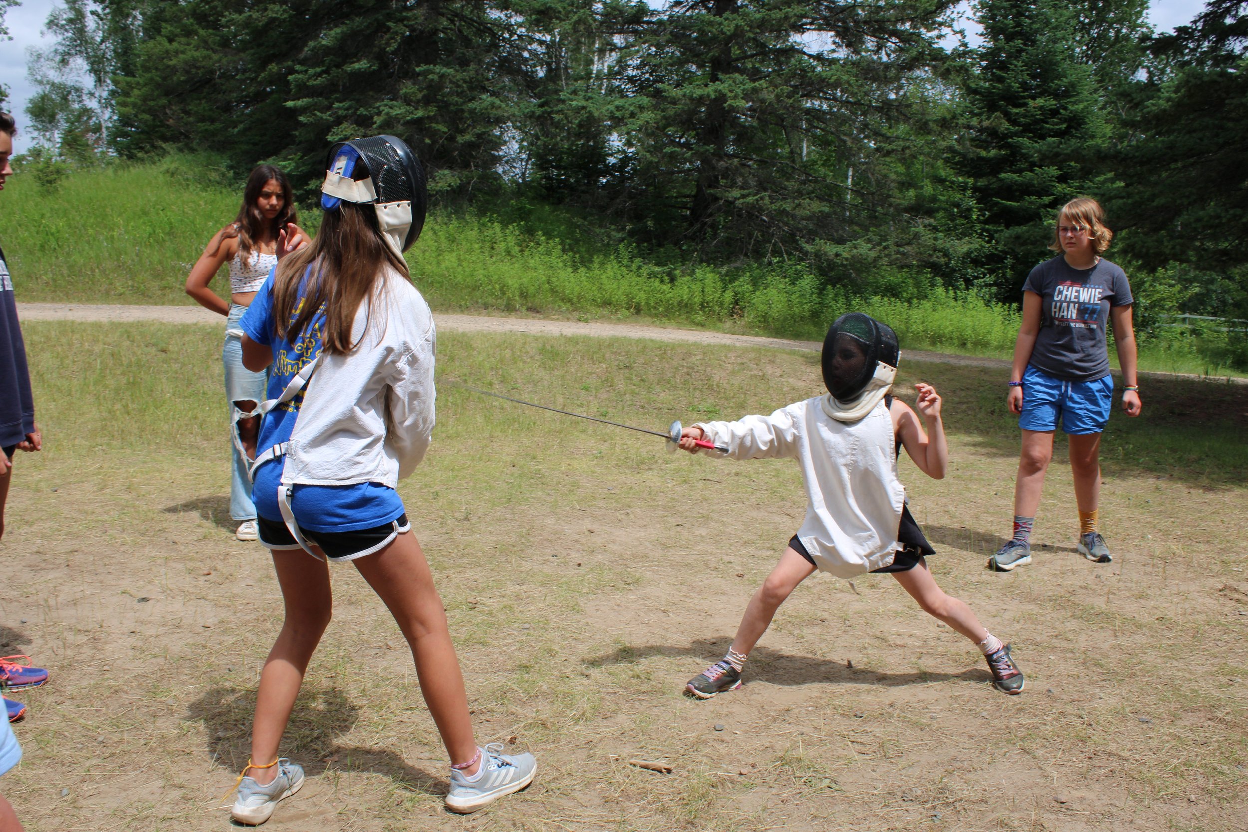 Fencing bout with fencers, director, and judges
