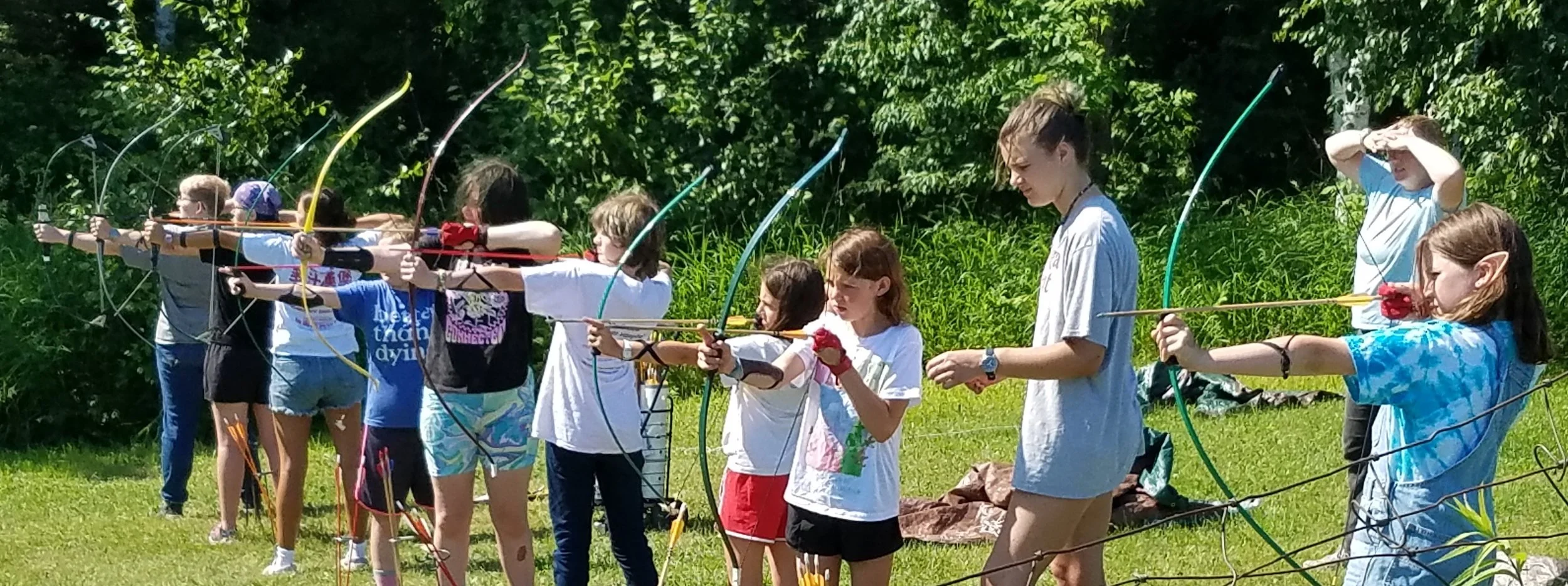 Archers aiming at targets at archery range.
