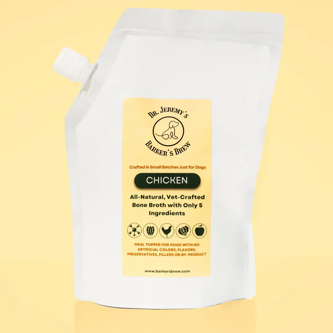 White dog food packaging bag labeled as Dr. Jeremy's Barker's Brew chicken bone broth for dogs, with small batch craft, natural ingredients, no artificial additives, and website www.barkersbrew.com.