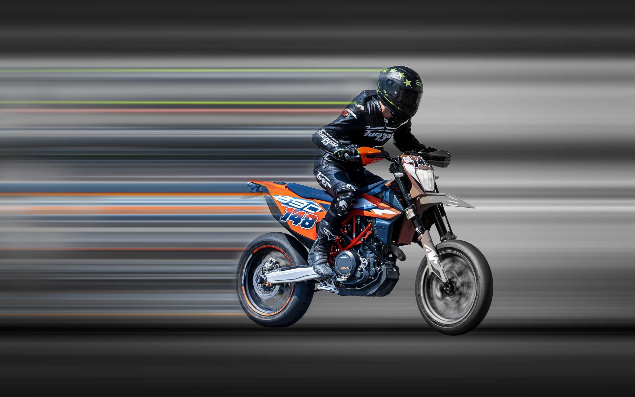 Creative motion-effect photograph of a motorcycle racer on an orange and blue supermoto bike, with horizontal pixel-stretch trails emphasizing speed and movement.
