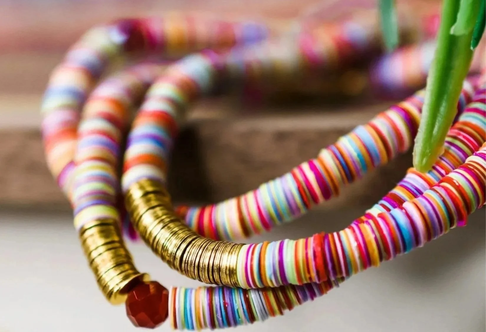 Closeup of a colorful band of beaded jewelry.