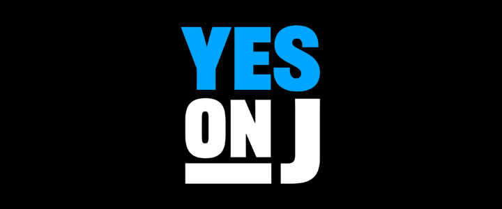Text saying 'YES ON J' with 'YES' in blue and the rest in white on a black background.