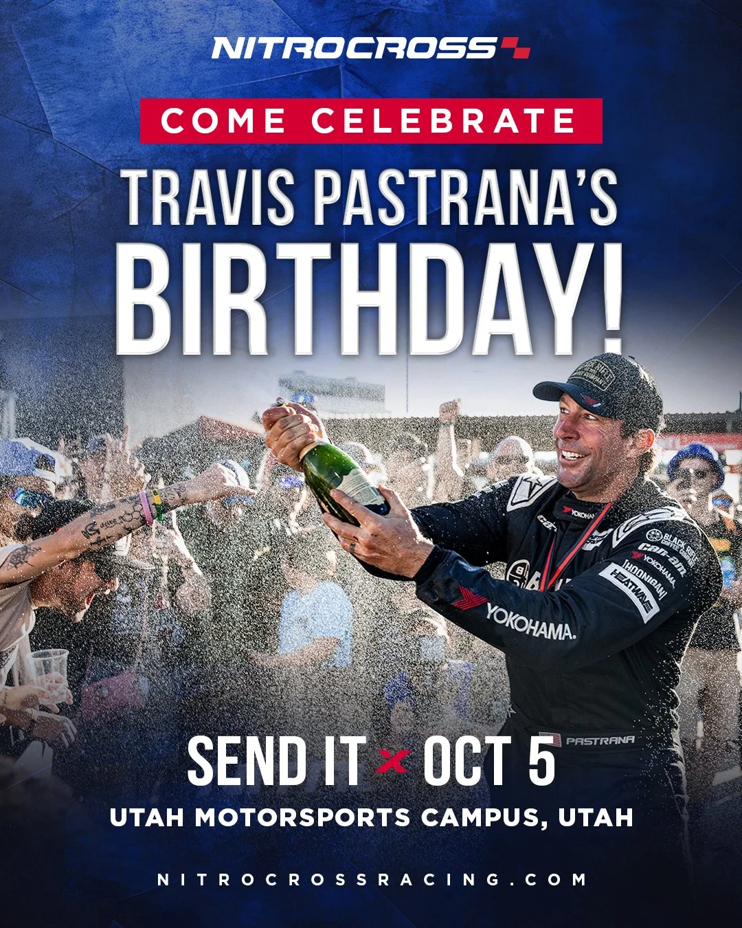 A racing driver celebrates with a champagne bottle at a party, crowd cheering around him, promoting Travis Pastrana's birthday celebration on October 5 at Utah Motorsports Campus, Utah.