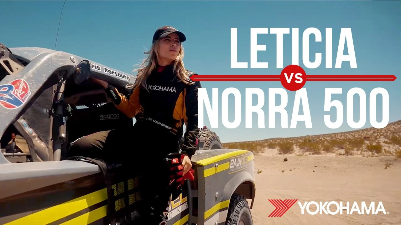 A woman sitting in a race car in a desert landscape, wearing racing gear, with the text "Leticia vs Norra 500" and the Yokohama logo