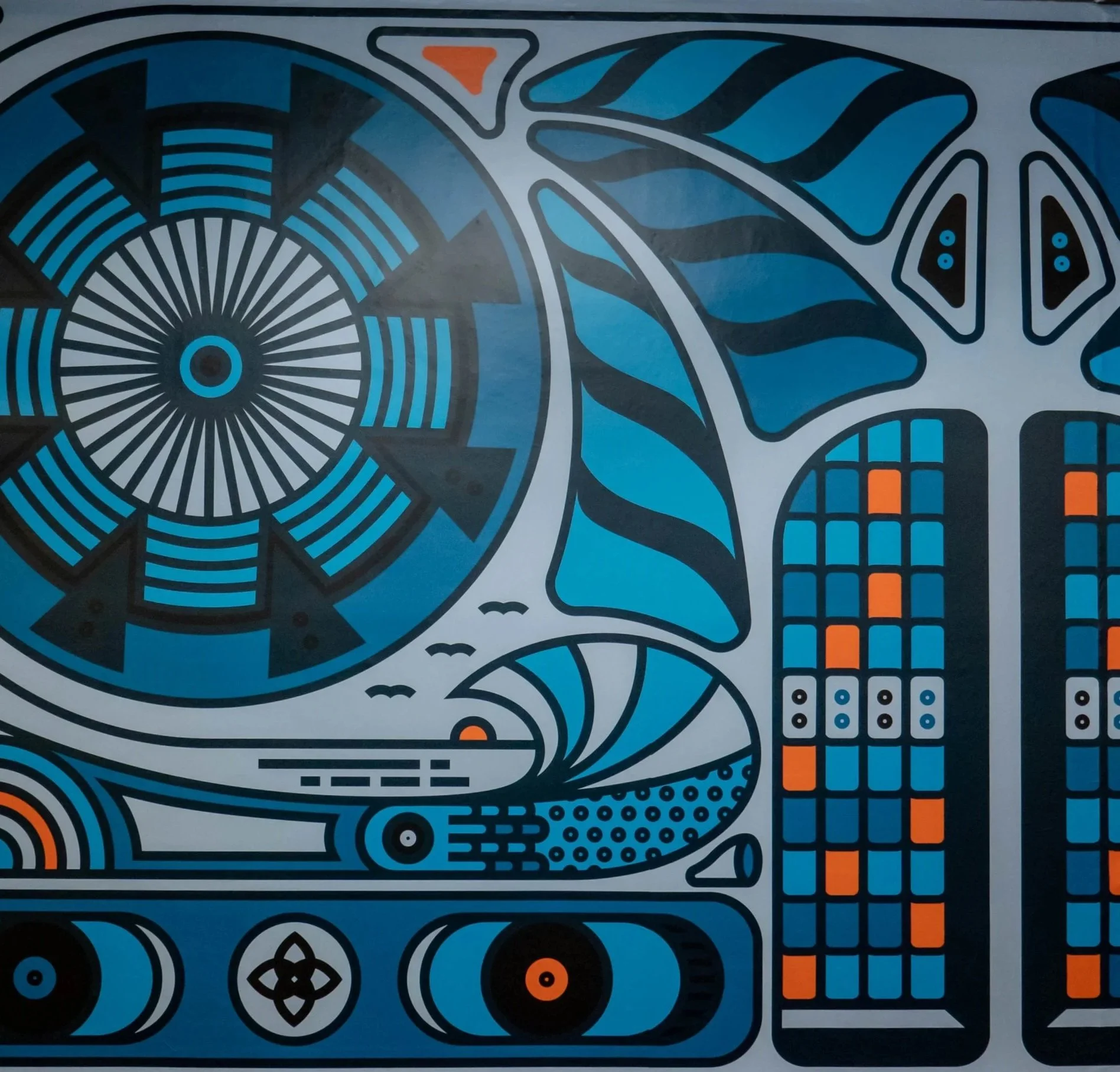 Abstract mural with geometric patterns in blue, black, gray, and orange. Features a circular design, stylized leaves, birds, windows, and a grid pattern.