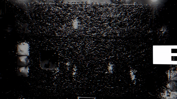 A large black sign with illuminated white letters spelling "EXIT" against a background of numerous small white lights.