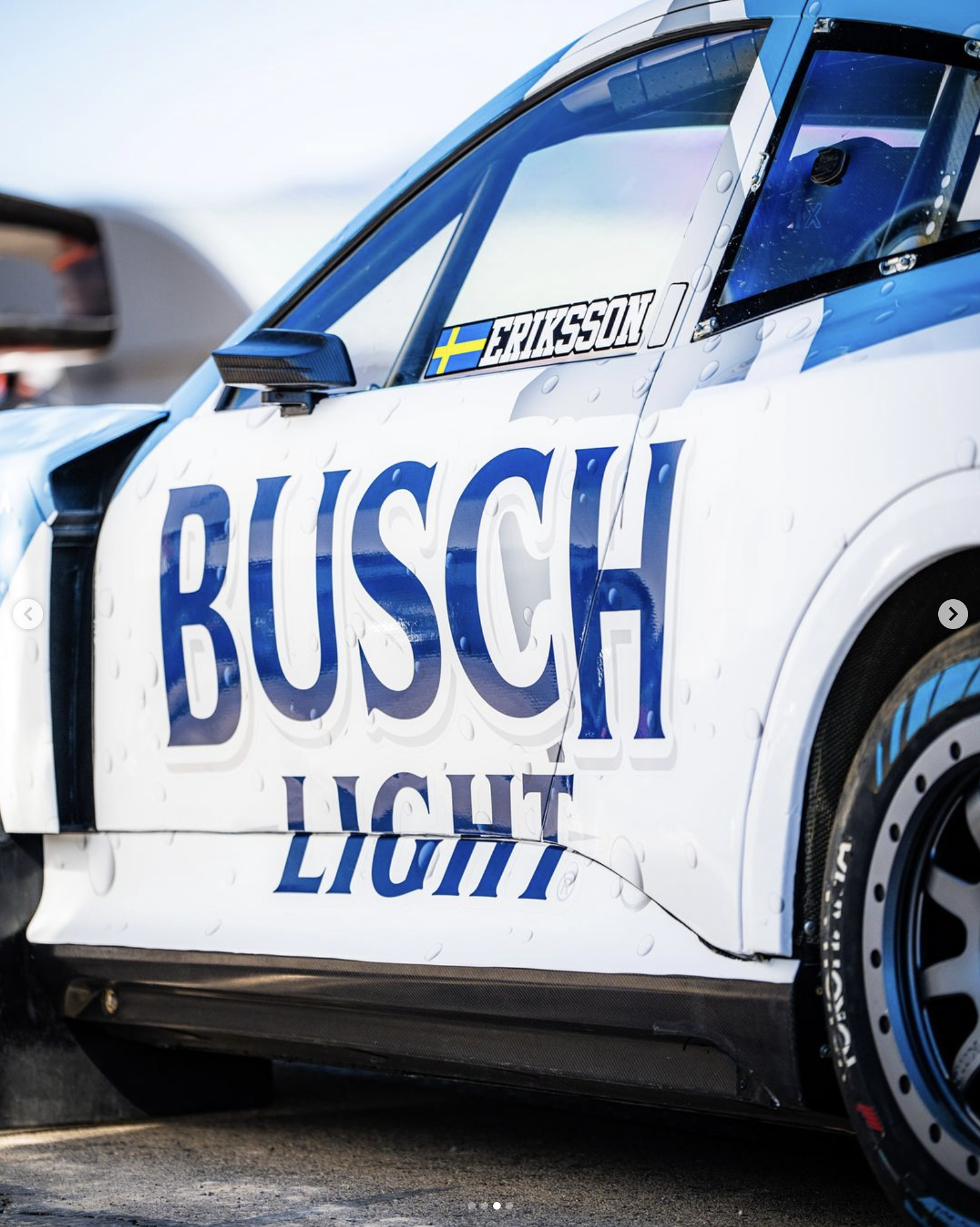 Close-up of a race car with sponsorship logo for Busch Light on the side and a Swedish flag next to the name Eriksson.