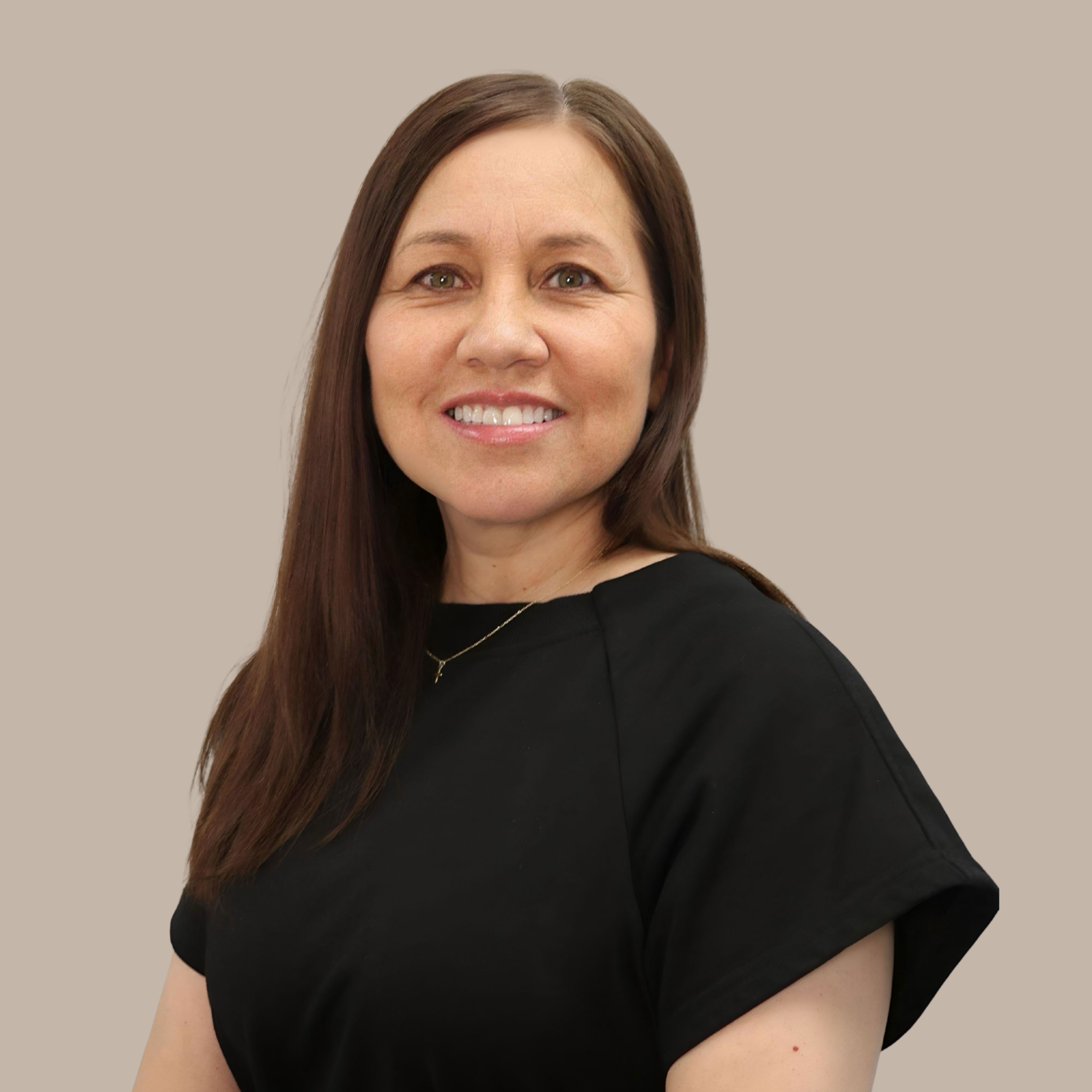 Portrait of a woman with long brown hair, wearing a black top, smiling, against a neutral background.