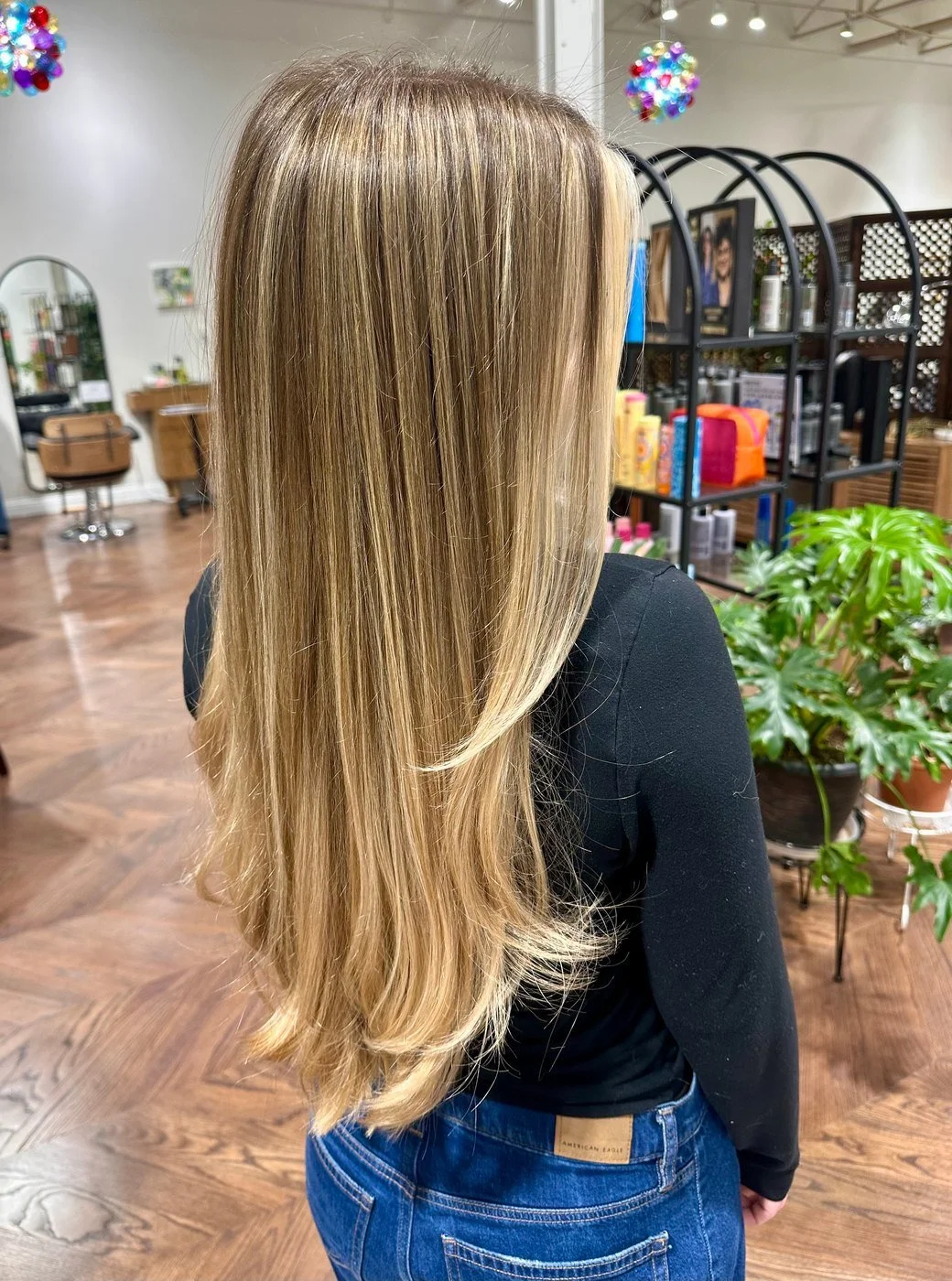 Long, straight hair seen from behind, darker at the root and blending to golden blonde through the lengths