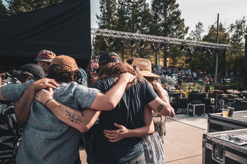Friends hugging backstage