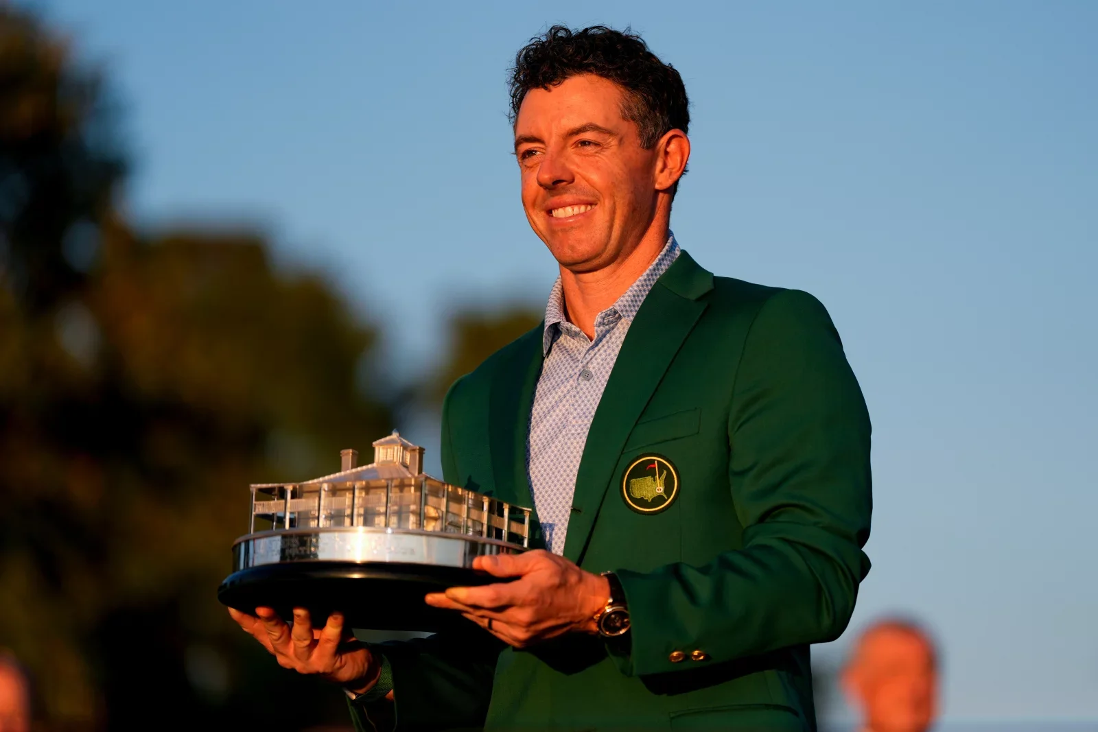 Rory McIlroy holding the Masters trophy in his green jacket after winning back-to-back titles at Augusta National