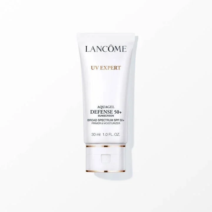 A white tube of Lancôme UV Expert Aquagel Defense 50+ sunscreen with SPF 50+ on a plain white background.