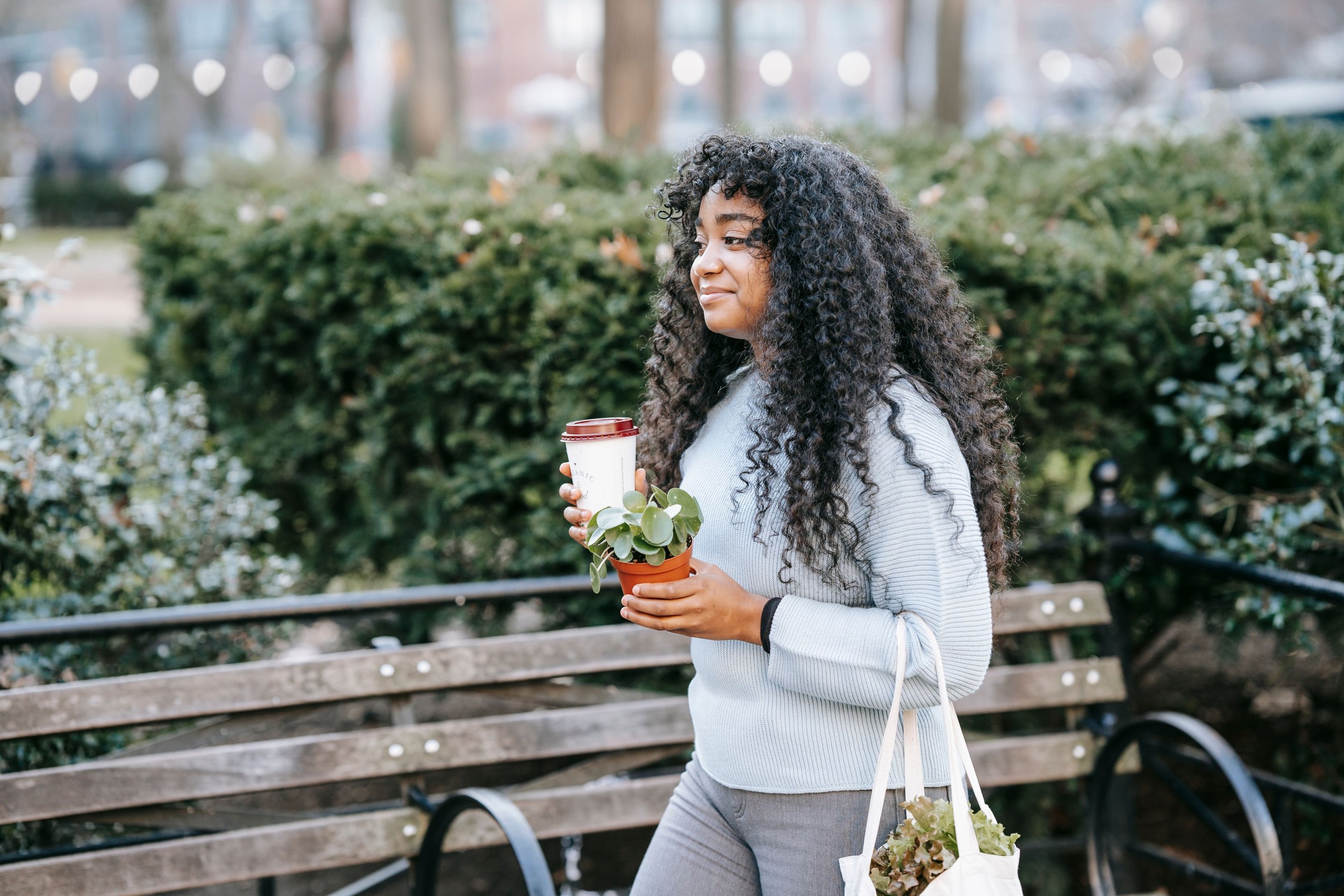 black woman with curly hair traveling in new city housesitting | The Sectional