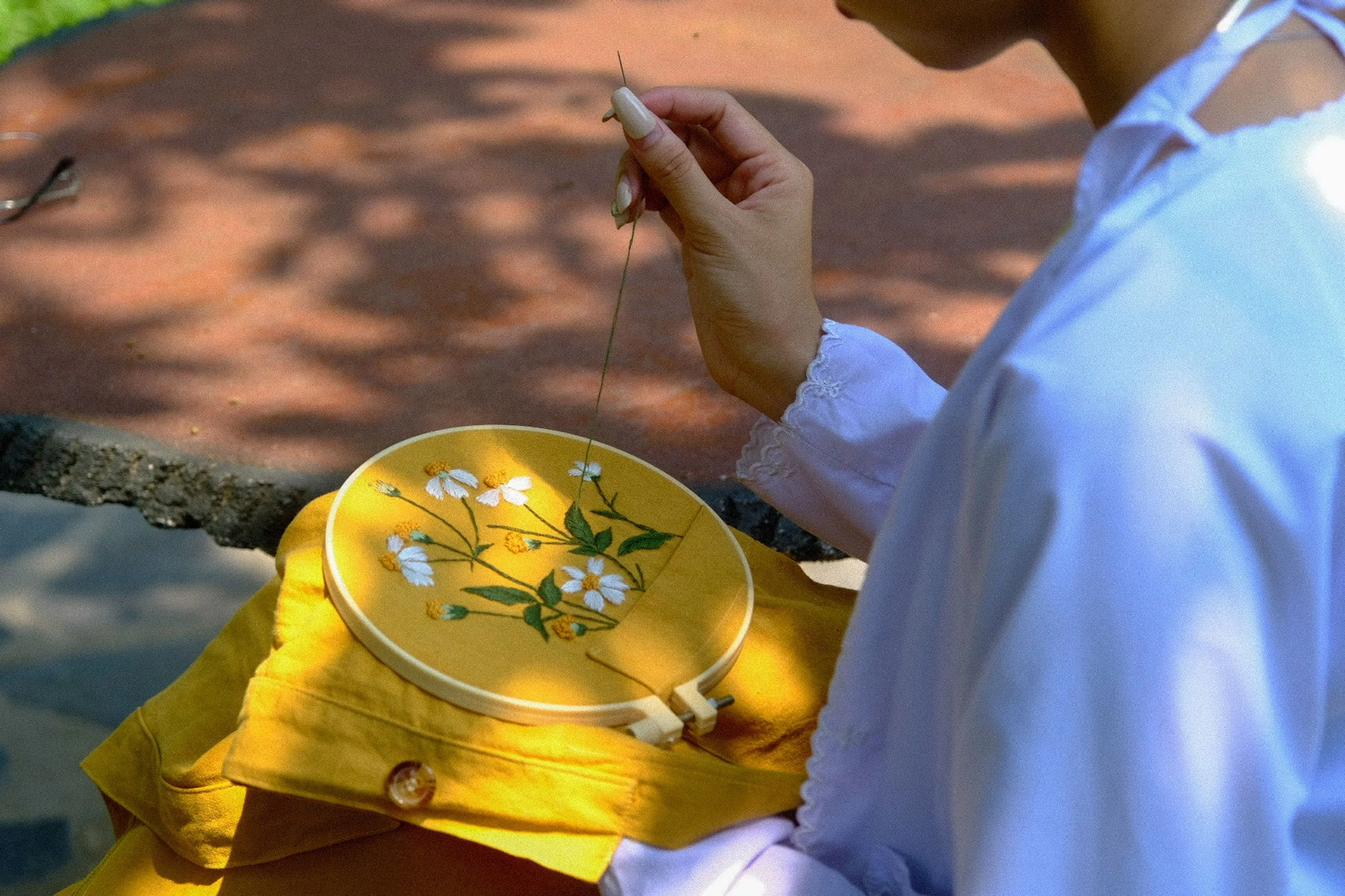 woman doing cross stitching | The Sectional
