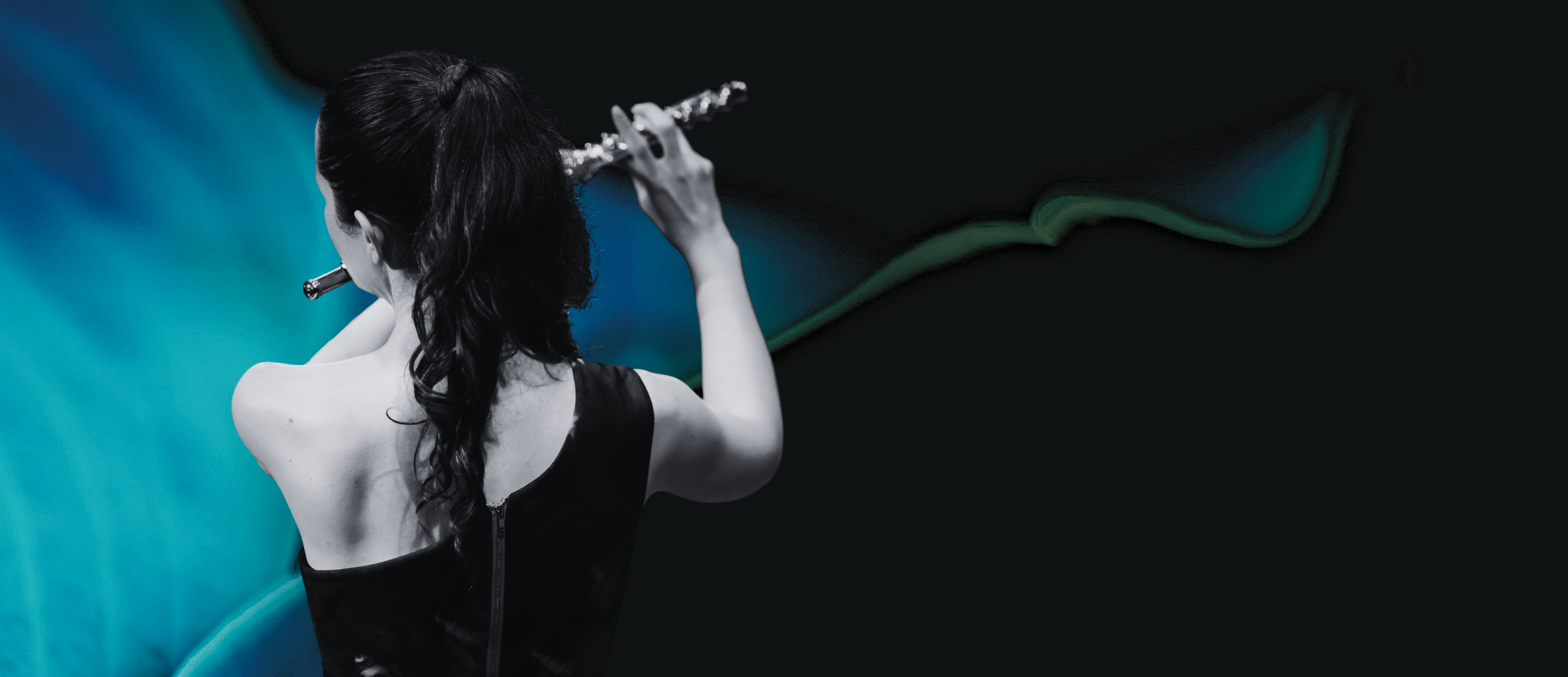 Woman with long dark hair playing a flute against a blue and black abstract background.
