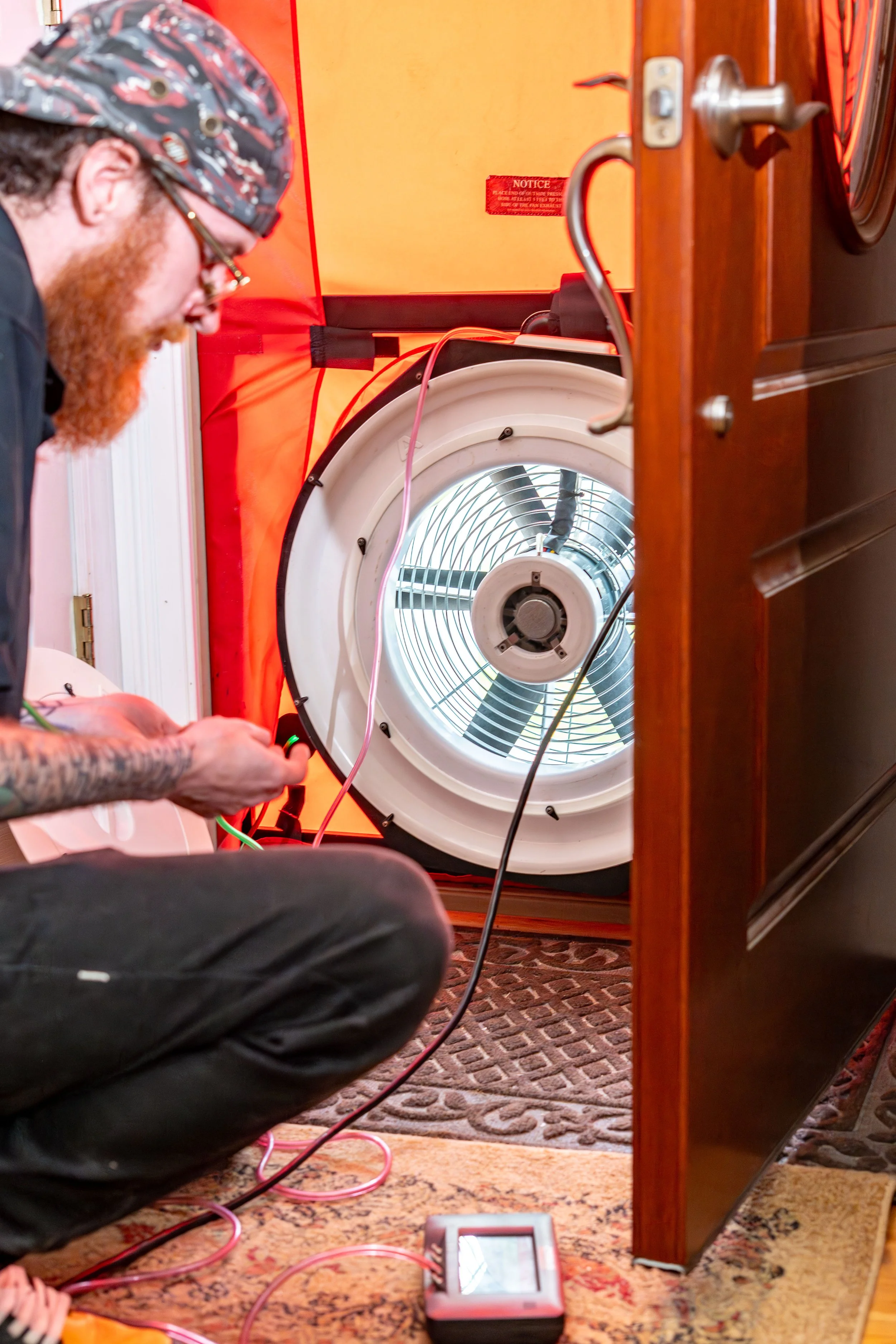Home Efficiency Experts employee working on a one of the many tests during a home energy assessment