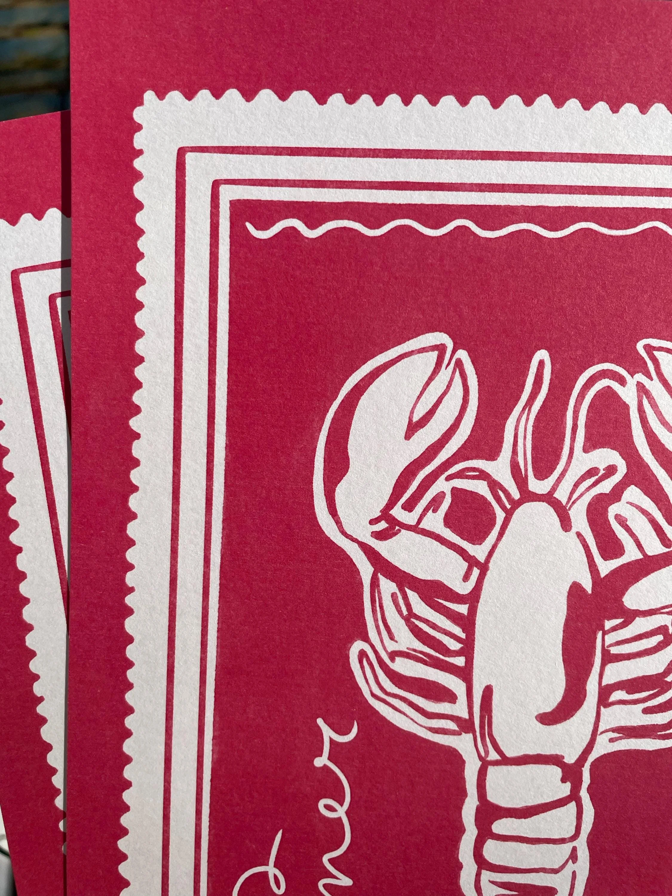 Details of a lobster wall art print. Textured, high quality paper emphasises the bold pink colour of the print and the hand-illustrated drawing.