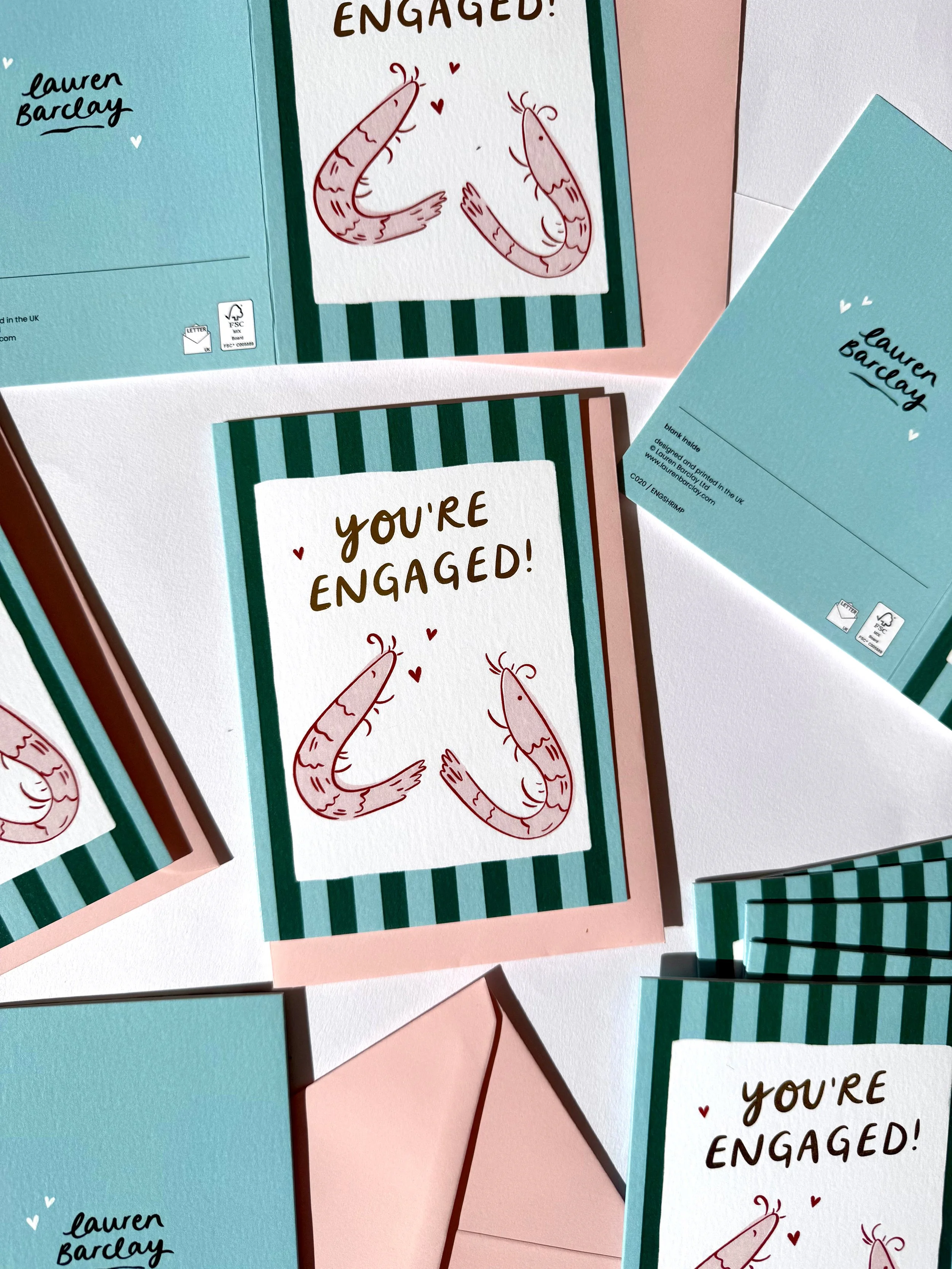 Hand illustrated engagement card featuring two cute shrimps and a trendy striped background.