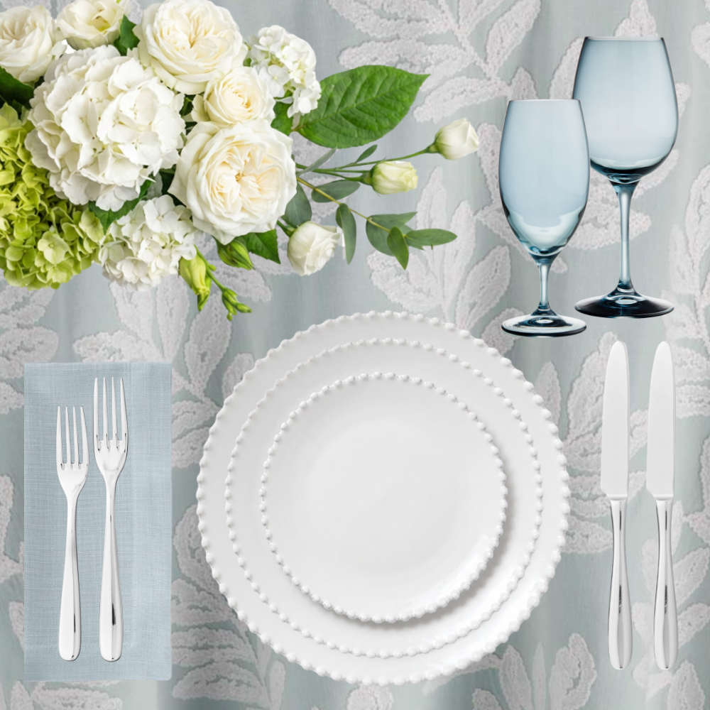 A beautiful blue and white embroidered table linen sets the base for this soft and delicate tablescape