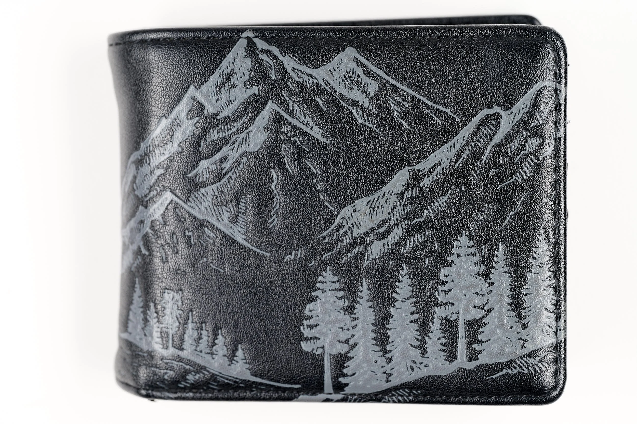 Black wallet with a silver mountain and forest landscape design.