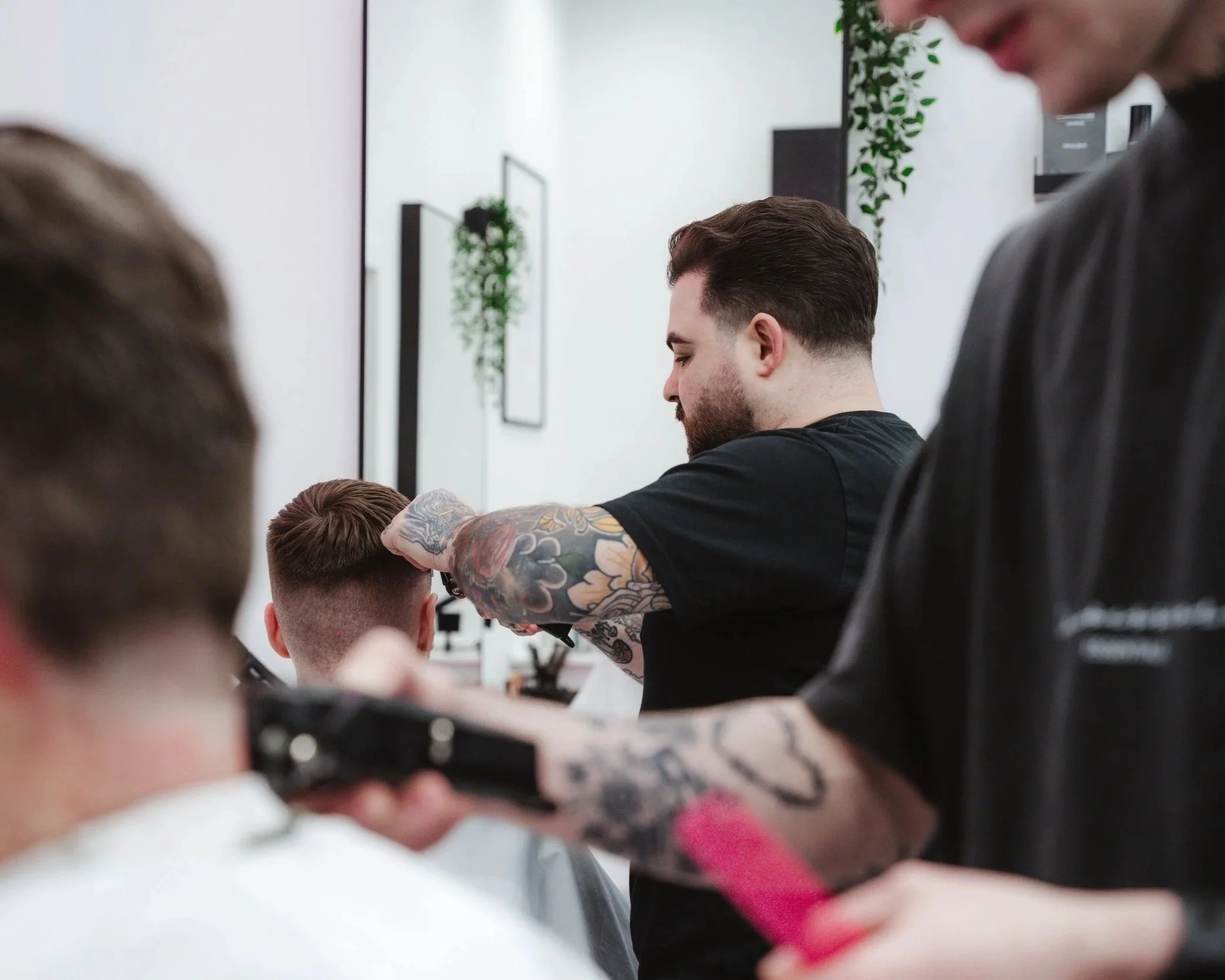 Barber cutting hair at Connoisseurs Barbershop in Leith Edinburgh