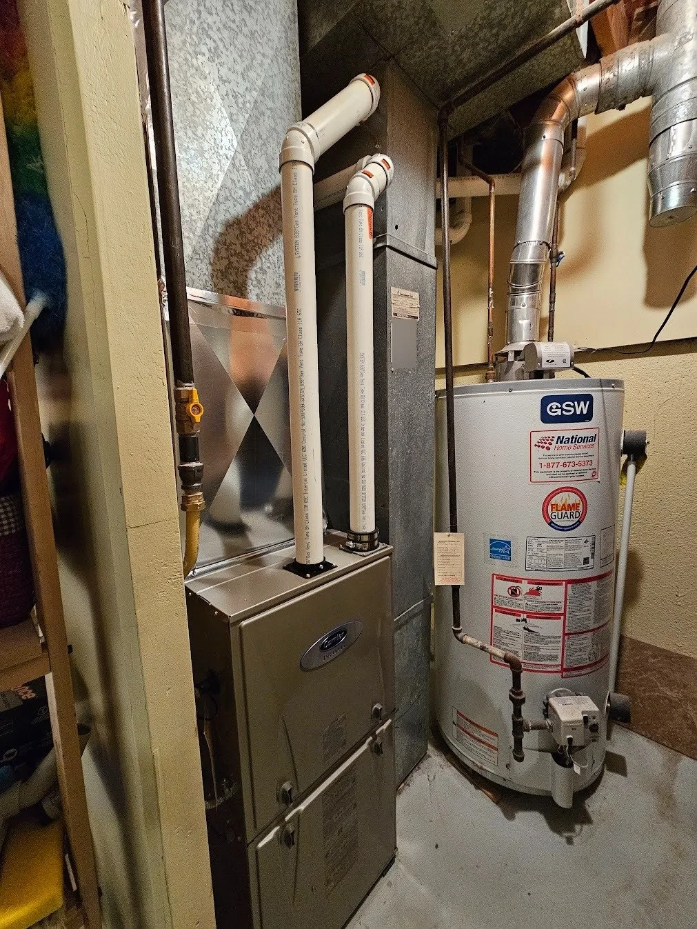 Water heater and HVAC furnace in a utility closet.