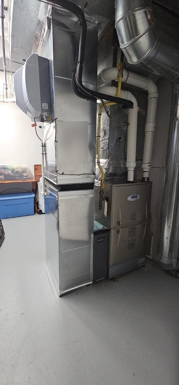 HVAC and ventilation system with ductwork, filters, and control units in a mechanical room.