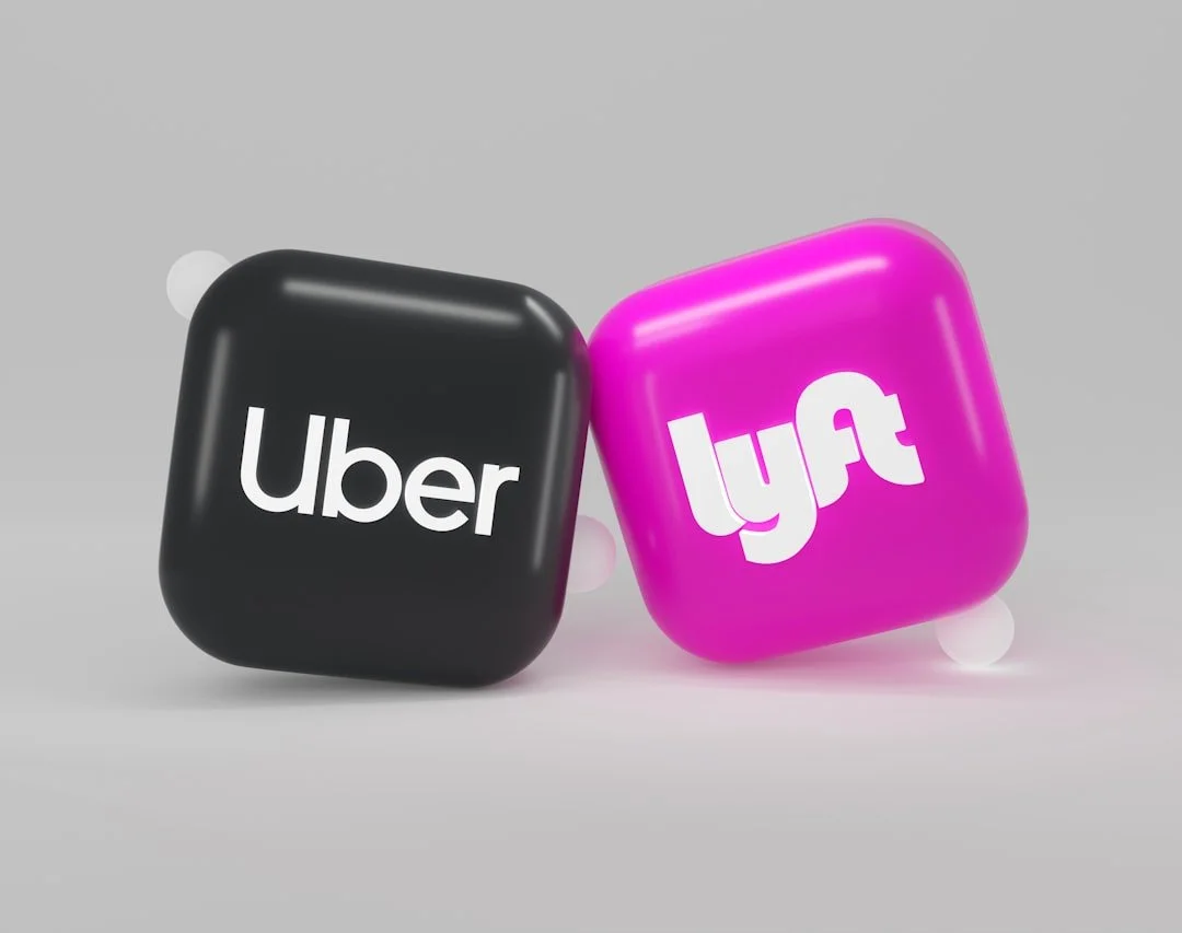 Uber and Lyft app icons depicted as 3D squares against a gray background.