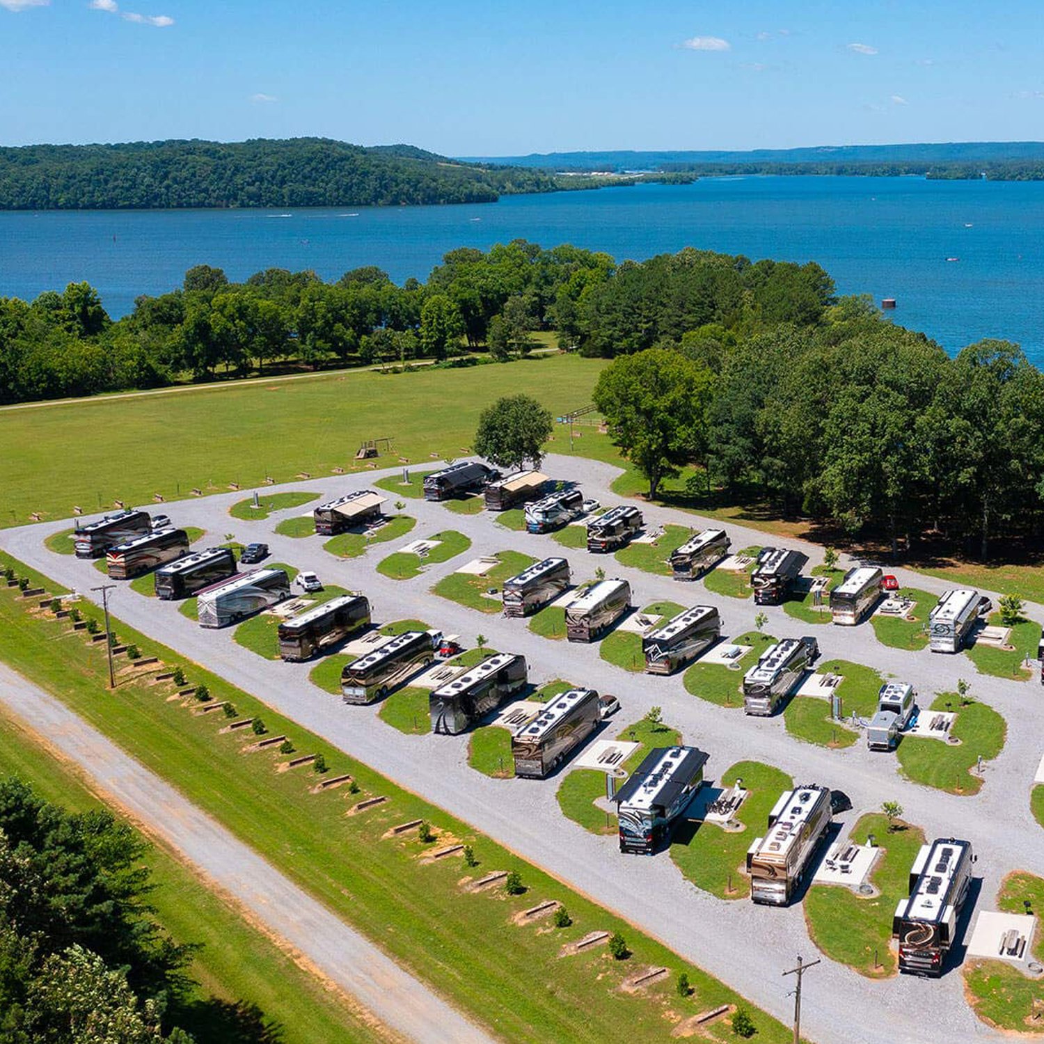 Aerial view of River Ridge with parked luxury coaches and a view of the water.