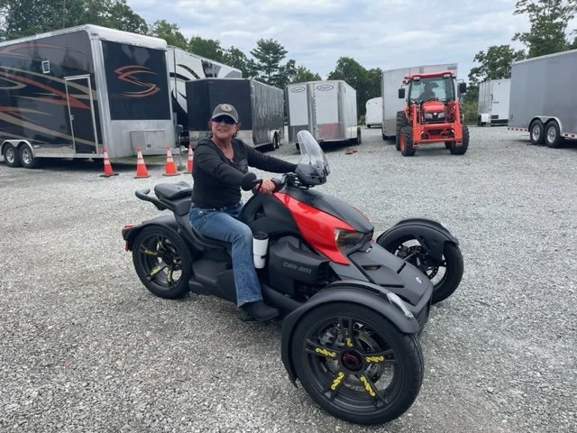 Bus 'n Biker member posing in the parking lot on her motorcycle.