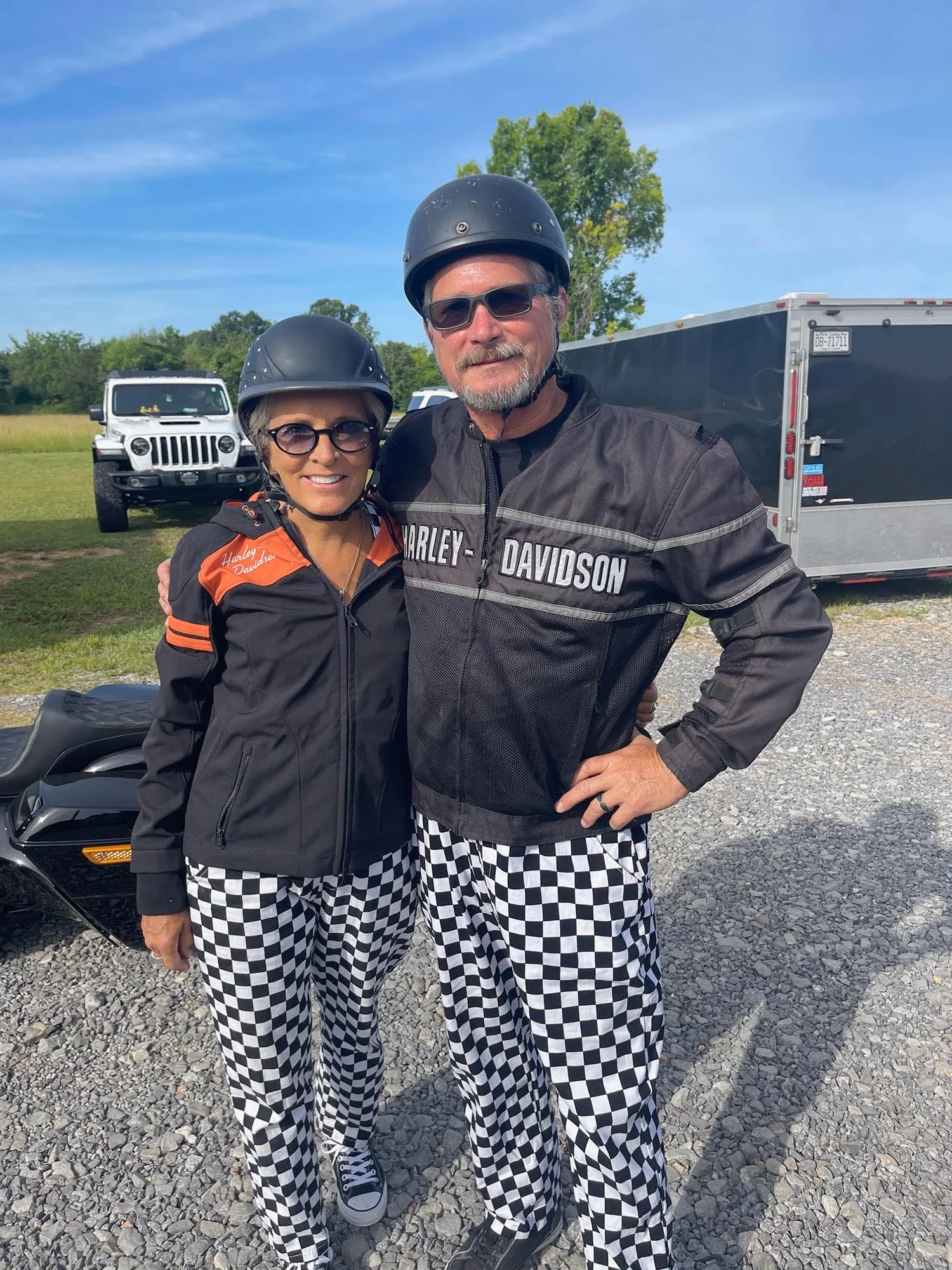 Bus'n Bikers members posing in front of a motorcycle.