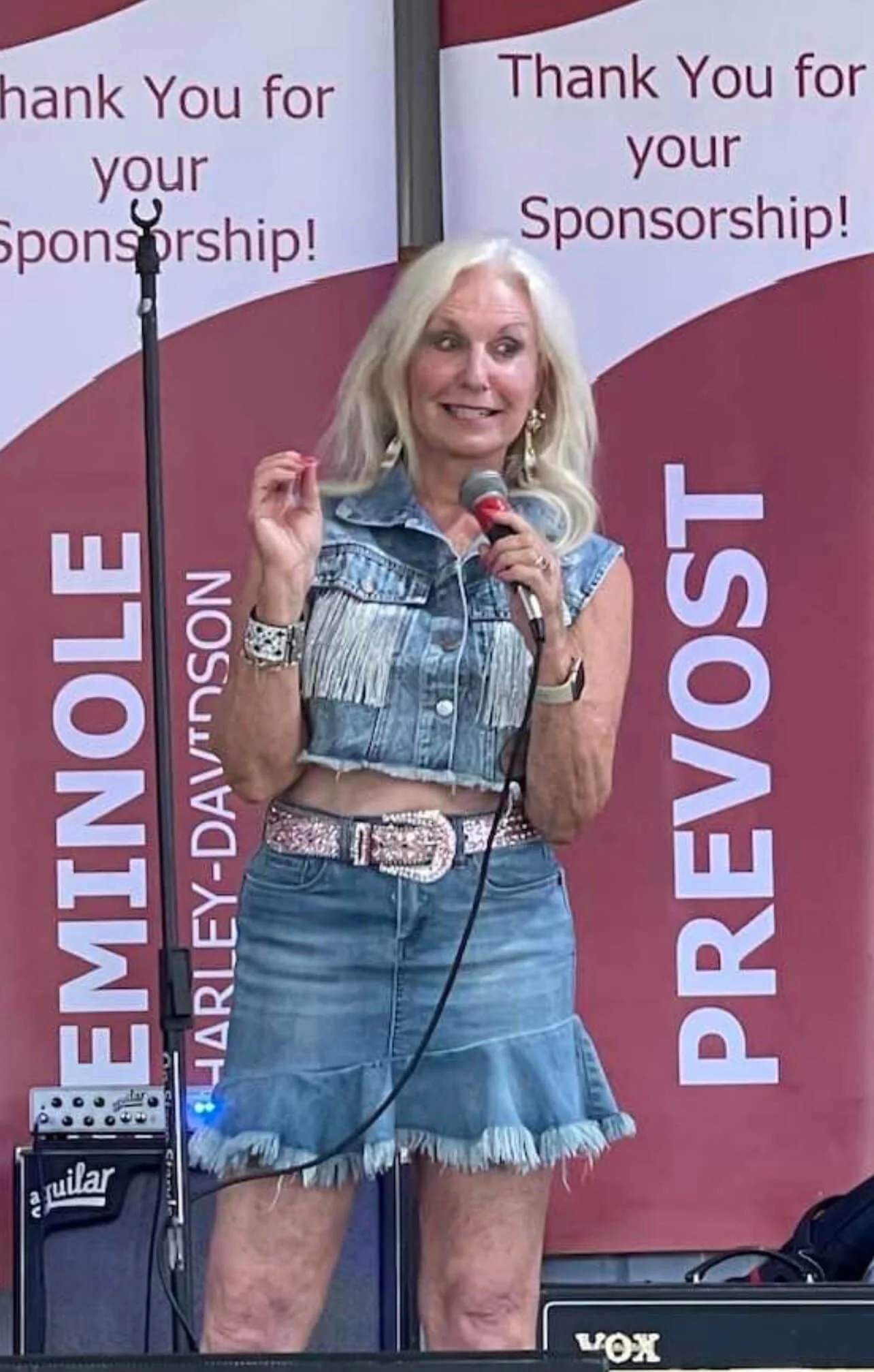 Pamela Fraizer speaking on stage at the Alabama Bus 'n Bikers rally.