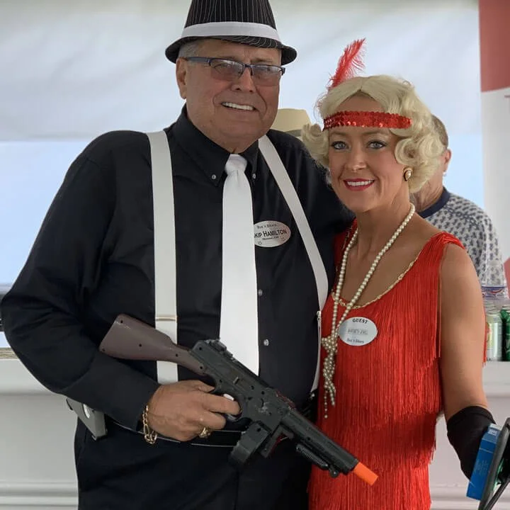Bus'n Bikers club members in 1920s gangster and flapper costumes at themed party event.