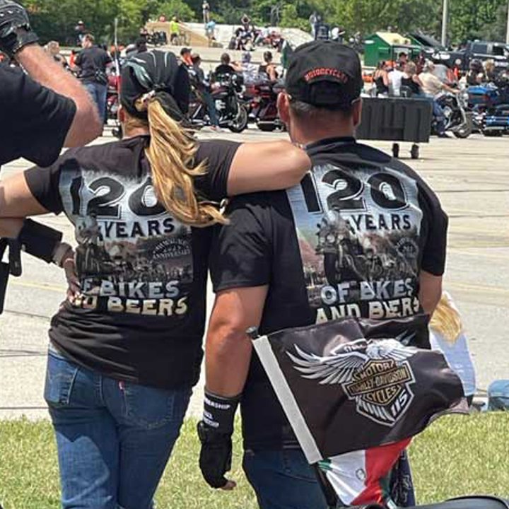 120 years Harley Davidson on t-shirts of two bikers.